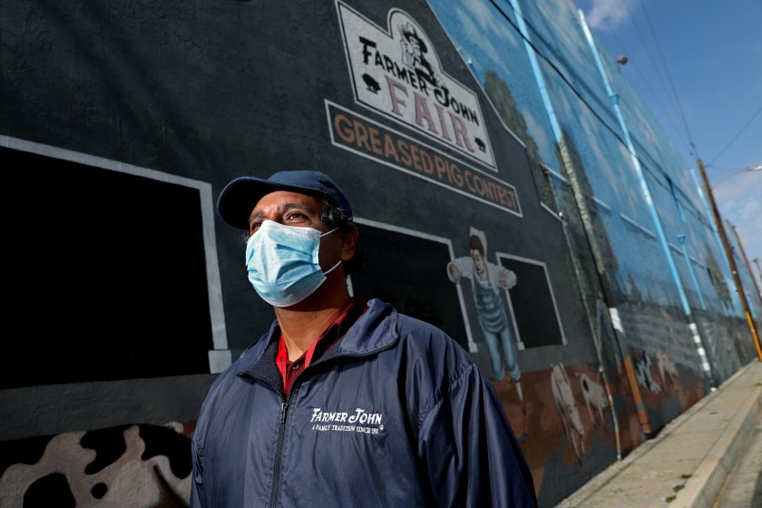 Pedro Albarran is seen at the Smithfield Foods-owned Farmer John plant on May 29 in Vernon, a city of about 200 residents. (Gary Coronado / Los Angeles Times)