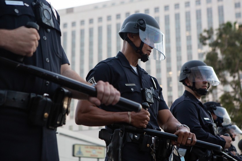 LAPD officers in riot gear form a police line during a May 27 Black Lives Matter protest in downtown L.A.(Gabriella Angotti-Jones / Los Angeles Times)