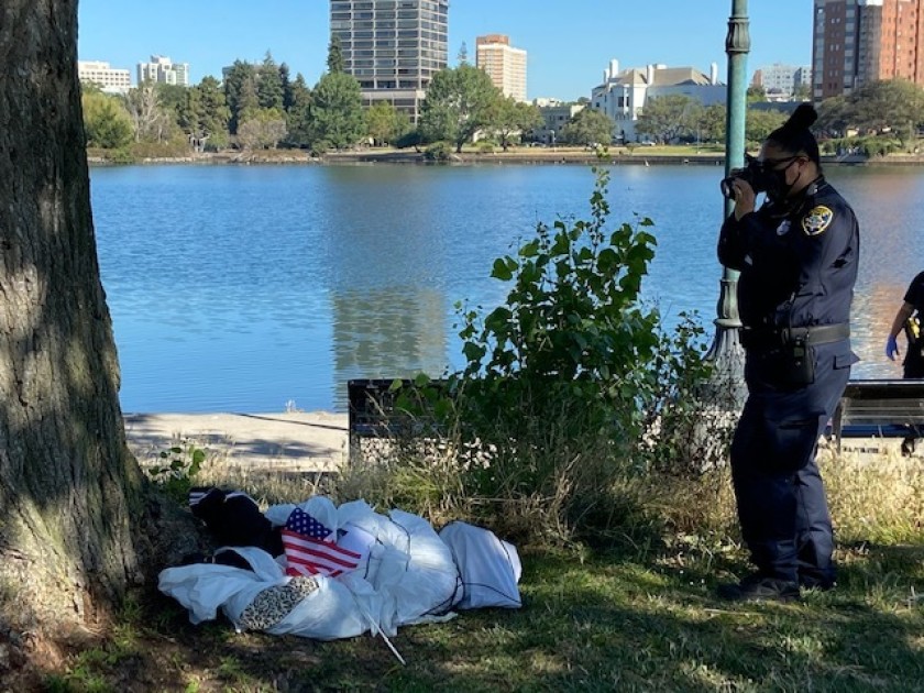 An effigy, a fake dead body, is investigated at Lake Merritt in Oakland on June 18, 2020, amid controversy over apparent nooses found hanging from trees the day before. (Oakland Police Department)