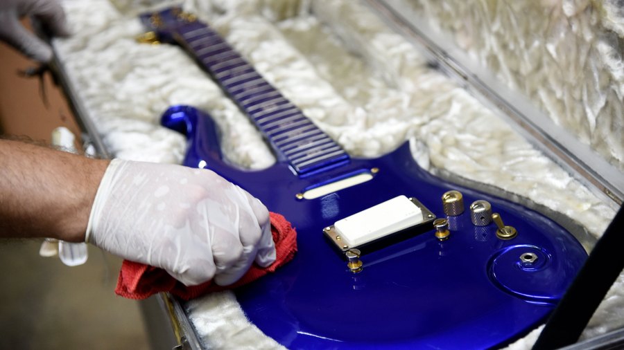 A blue "cloud" guitar custom-made in the 1980s for the late musician Prince is polished at Julien's Auctions warehouse on May 6, 2020, in Culver City. (AP Photo/Chris Pizzello via CNN)