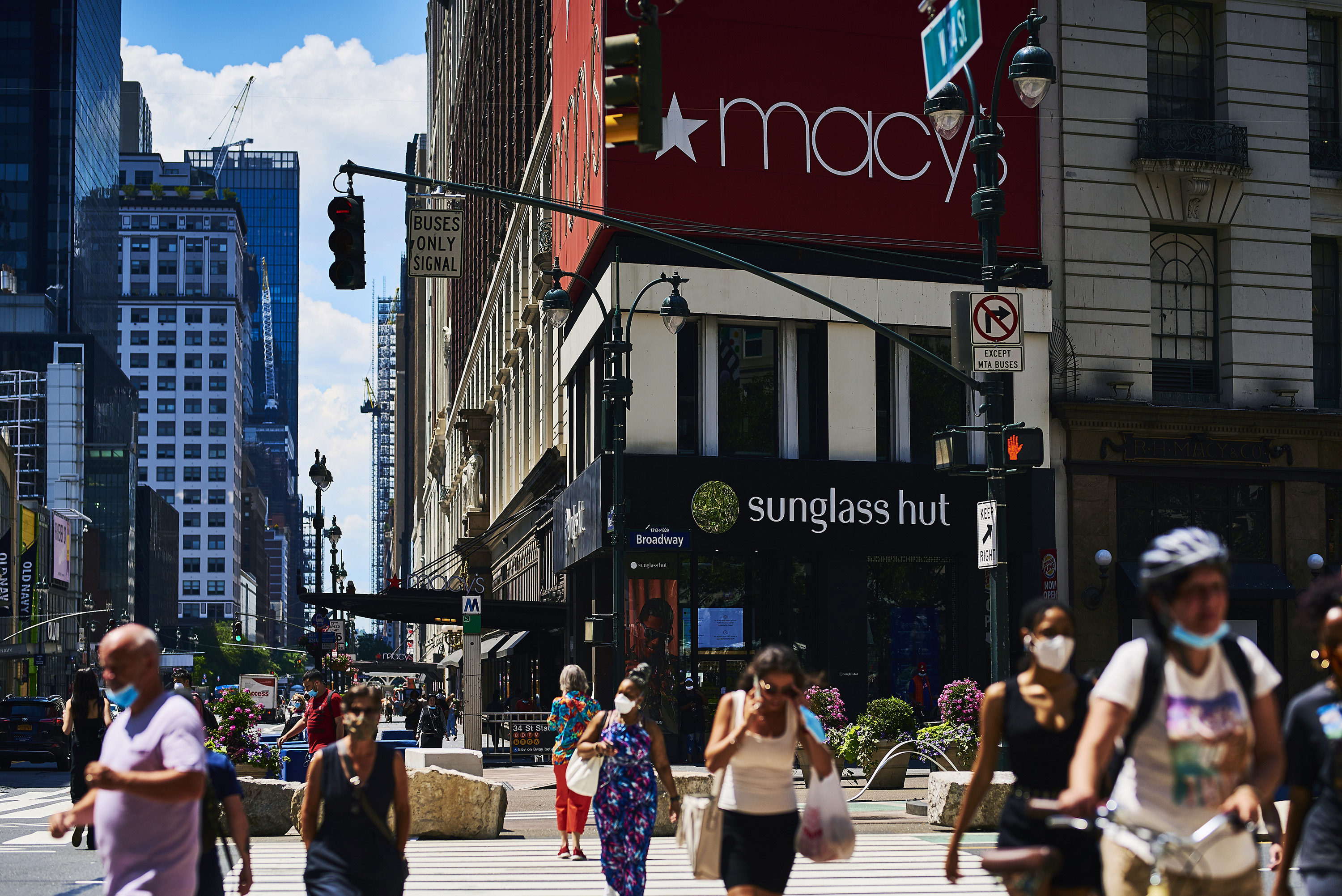 Pedestrians cross a street in front of the Macy's Inc. flagship store in the Herald Square area of New York, U.S., on June 22, 2020. (Gabby Jones/Bloomberg via Getty Images)