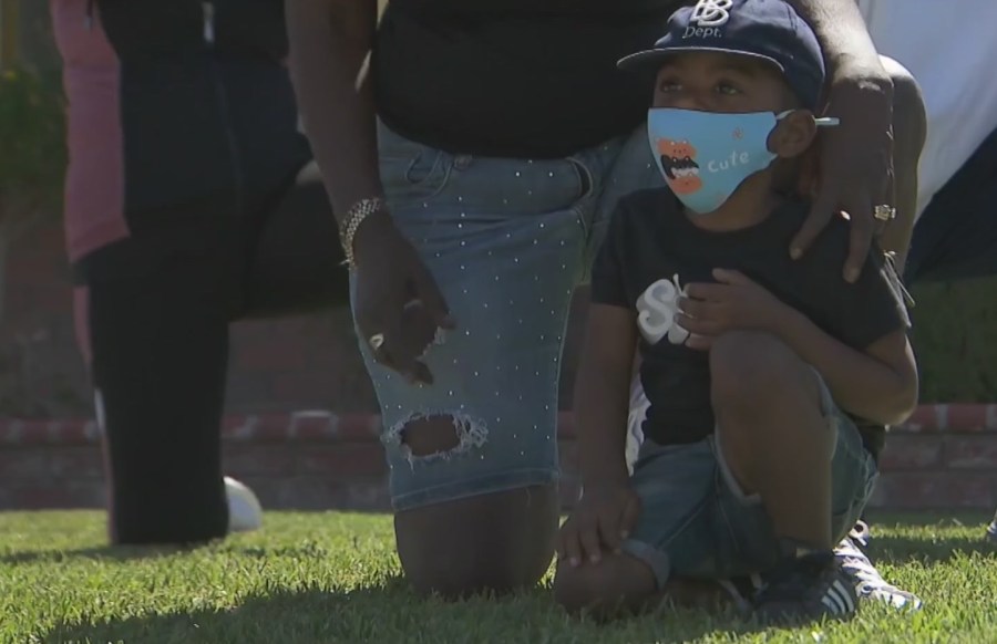 A boy kneels during a "Take a Knee for Peace" protest in Gardena, a demonstration against racial inequality, on June 7, 2020. (KTLA)