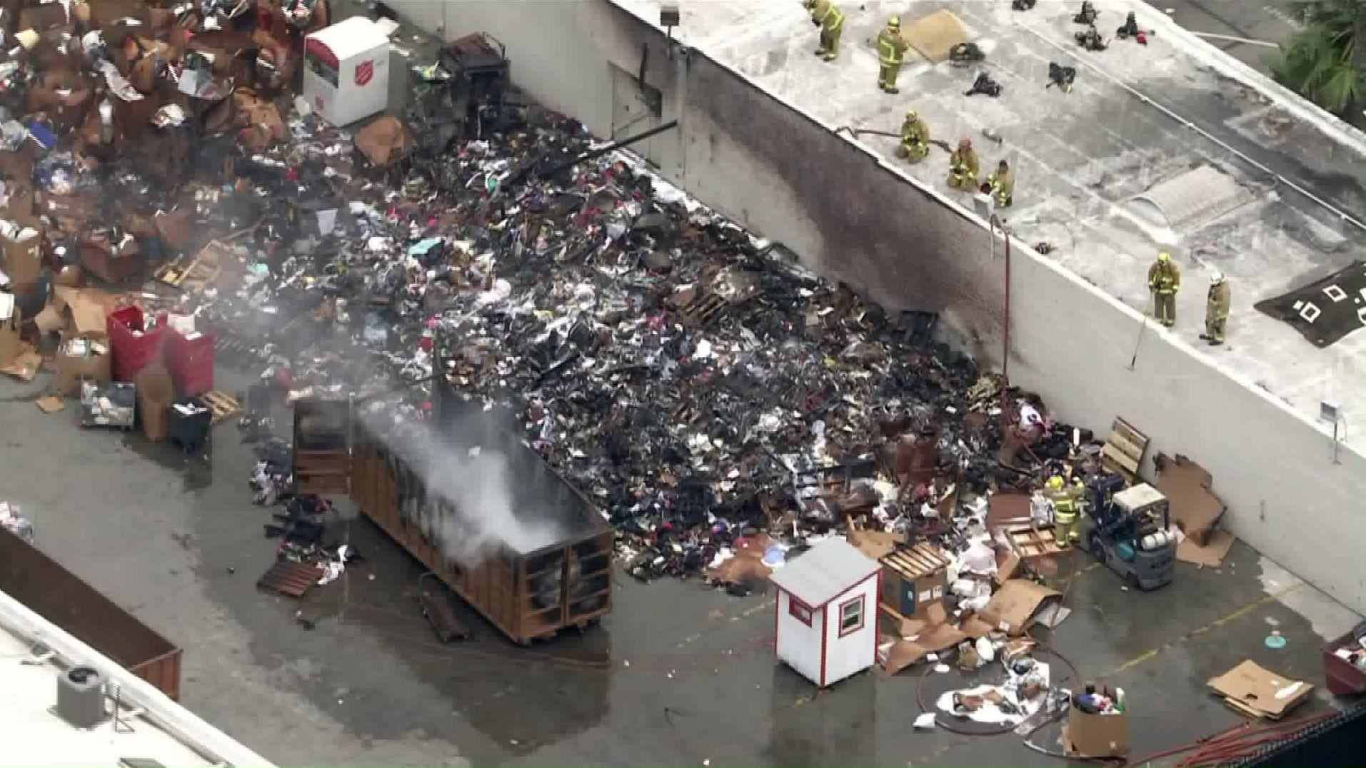 Piled up donations burned outside a Salvation Army store in Pasadena on June 17, 2020. (KTLA)