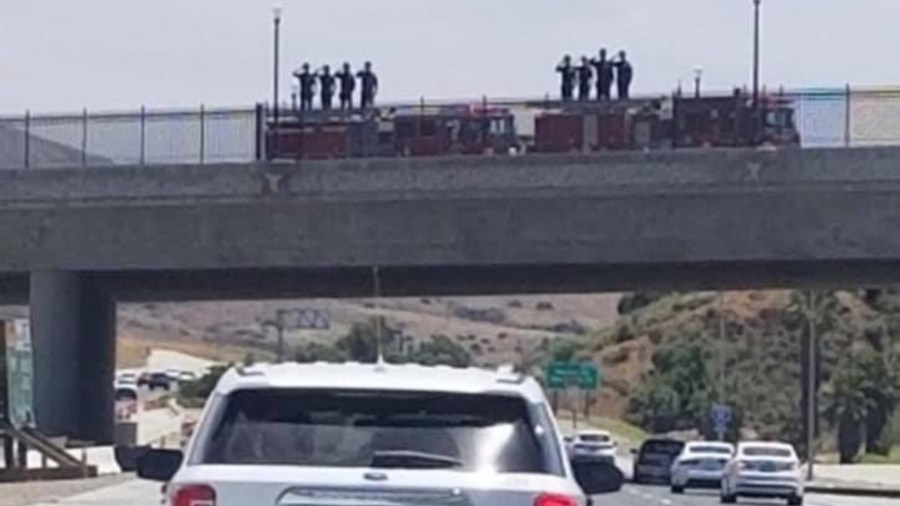 An image of fire department personnel saluting during a procession was posted on the CACorrections Facebook page.