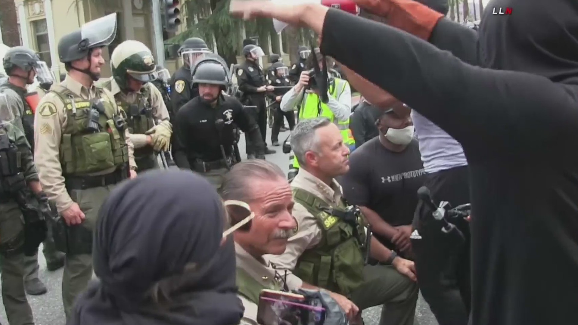 Riverside County Sheriff Chad Bianco takes a knee with demonstrators on June 1, 2020. (LLN)