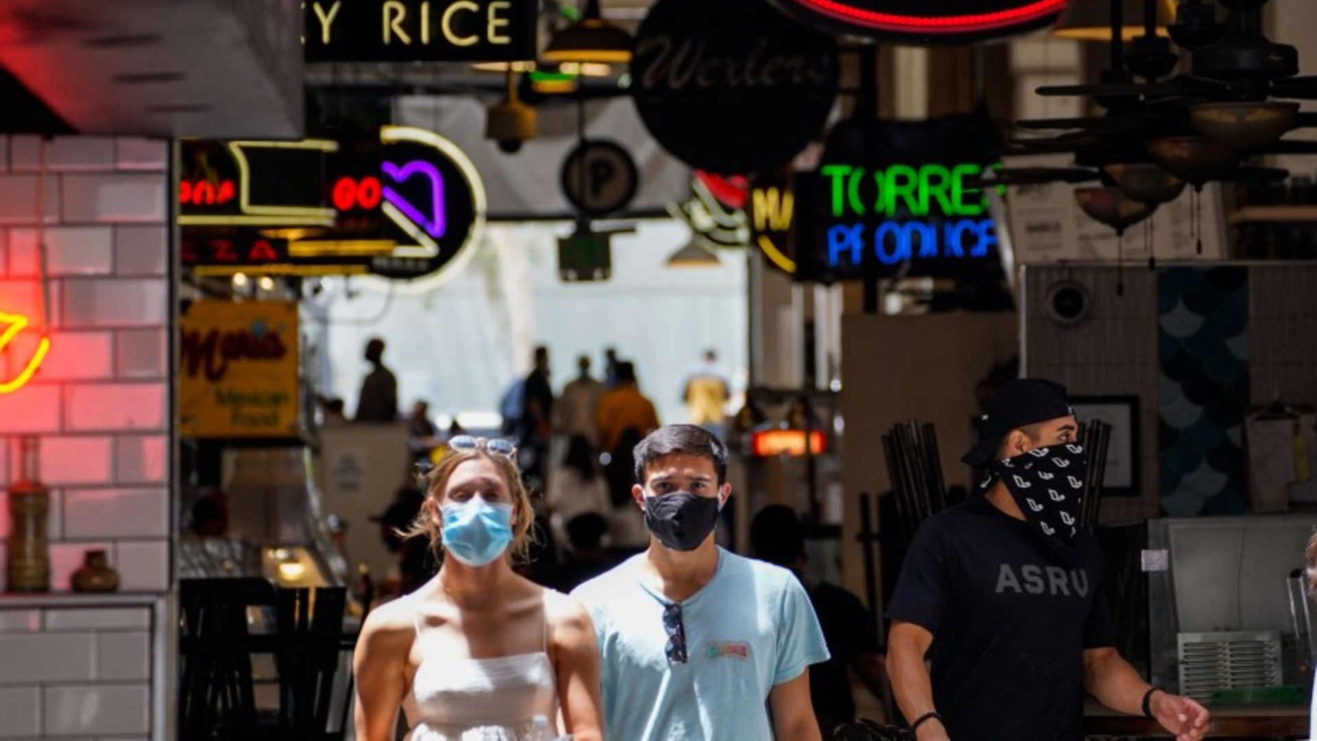 People wear face coverings at Grand Central Market in downtown Los Angeles on Thursday.(Kent Nishimura / Los Angeles Times)