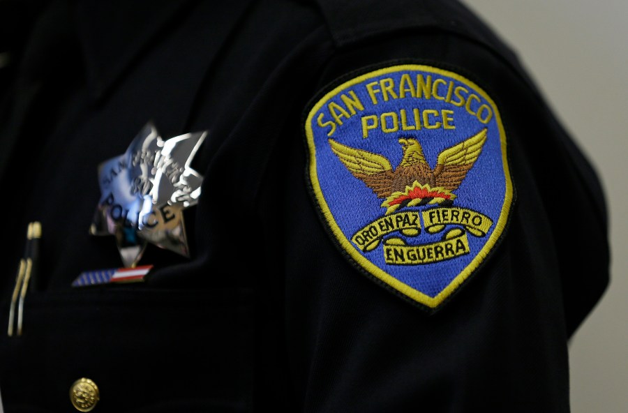 This April 29, 2016, file photo, shows a patch and badge on the uniform of a San Francisco police officer in San Francisco. The San Francisco Police Department will stop releasing mugshots of people arrested unless they pose a threat in an effort to stop perpetuating racial stereotypes, the police chief announced Wednesday, July 1, 2020. (AP Photo/Eric Risberg, File)