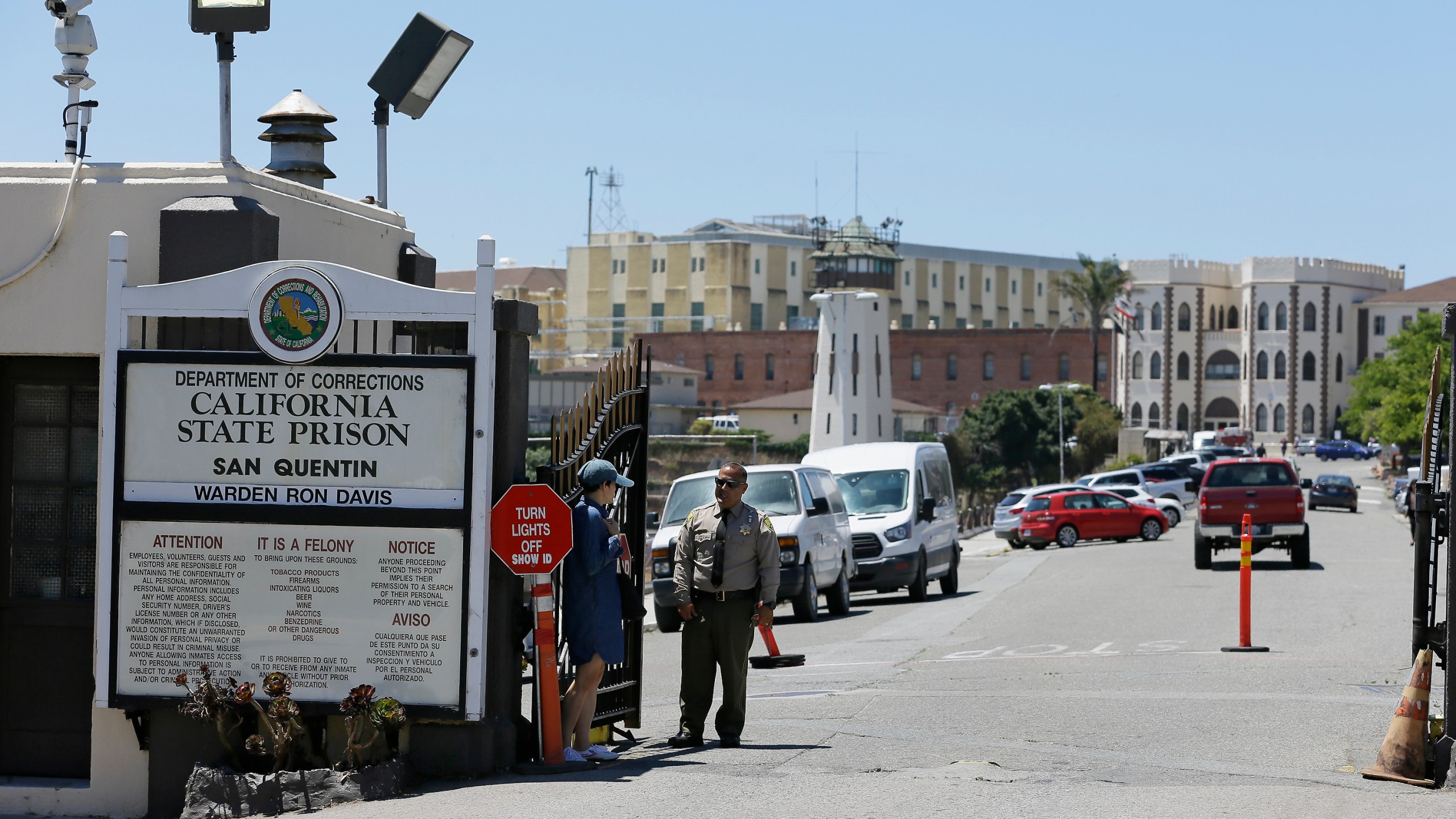 A Department of Corrections officer guards the main entryway leading into San Quentin State Prison on July 24, 2019. (AP Photo/Eric Risberg, File)