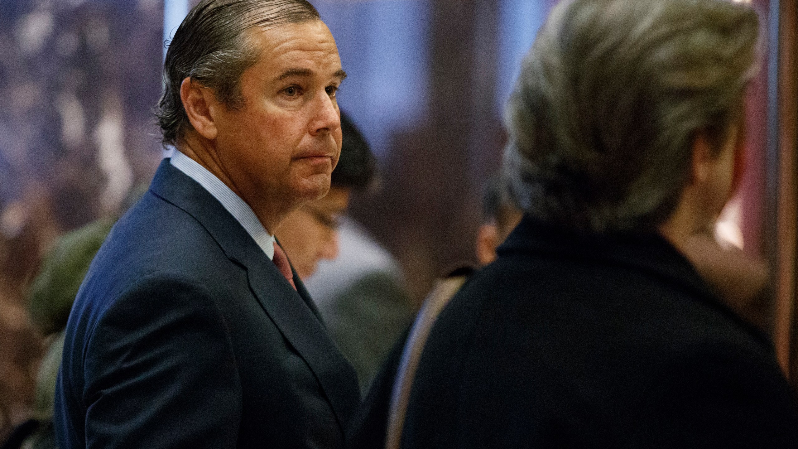 In this Nov. 30, 2016, file photo, investor Ray Washburne waits for an elevator in the lobby of Trump Tower in New York. (AP Photo/Evan Vucci)