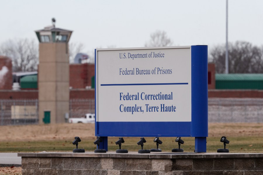 The guard tower flanks the sign at the entrance to the U.S. Penitentiary in Terre Haute, Indiana, on Dec. 10, 2019. (Michael Conroy / Associated Press)