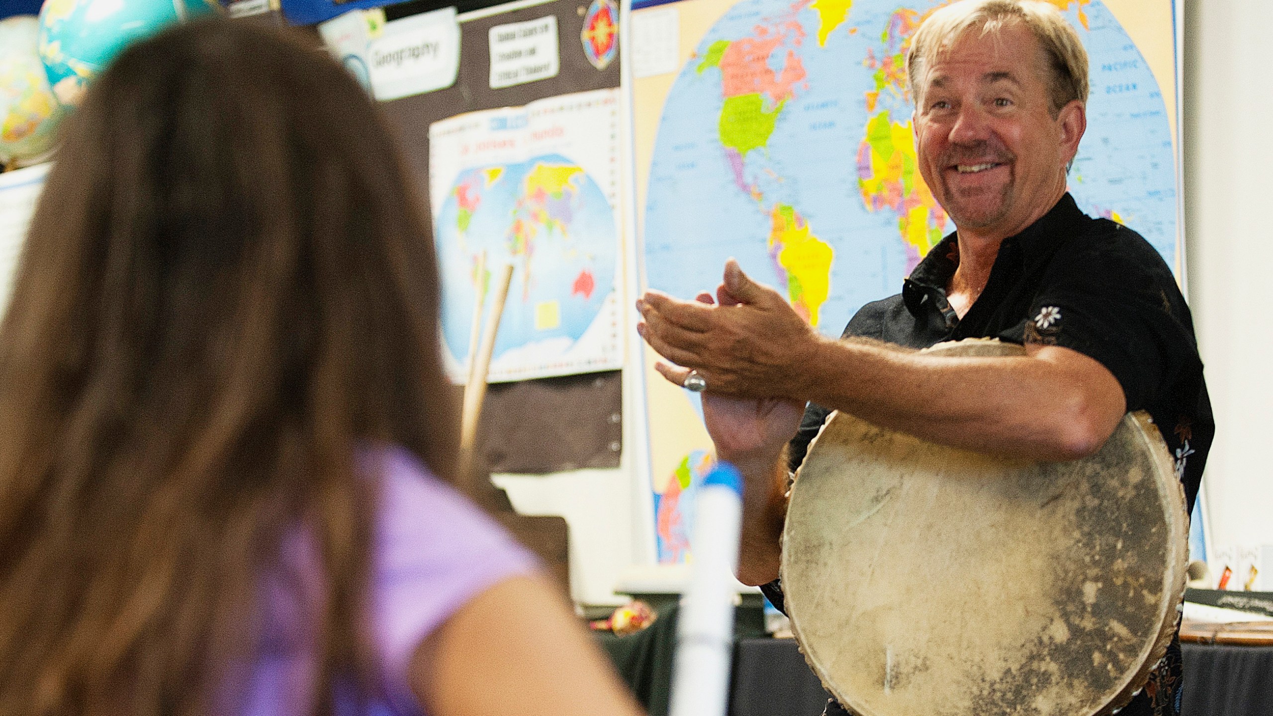 In this 2016 file photo, music teacher John Zeretzke, right, applauds his students after they performed a piece with flutes they built in his class in Lake Forest, Calif. Zeretzke, the founder of an international music program who was accused of giving semen-tainted flutes to California elementary school students, was sentenced to 18 years in state prison, the state attorney's office said Wednesday, July 8, 2020. (Nick Koon/The Orange County Register via Associated Press)