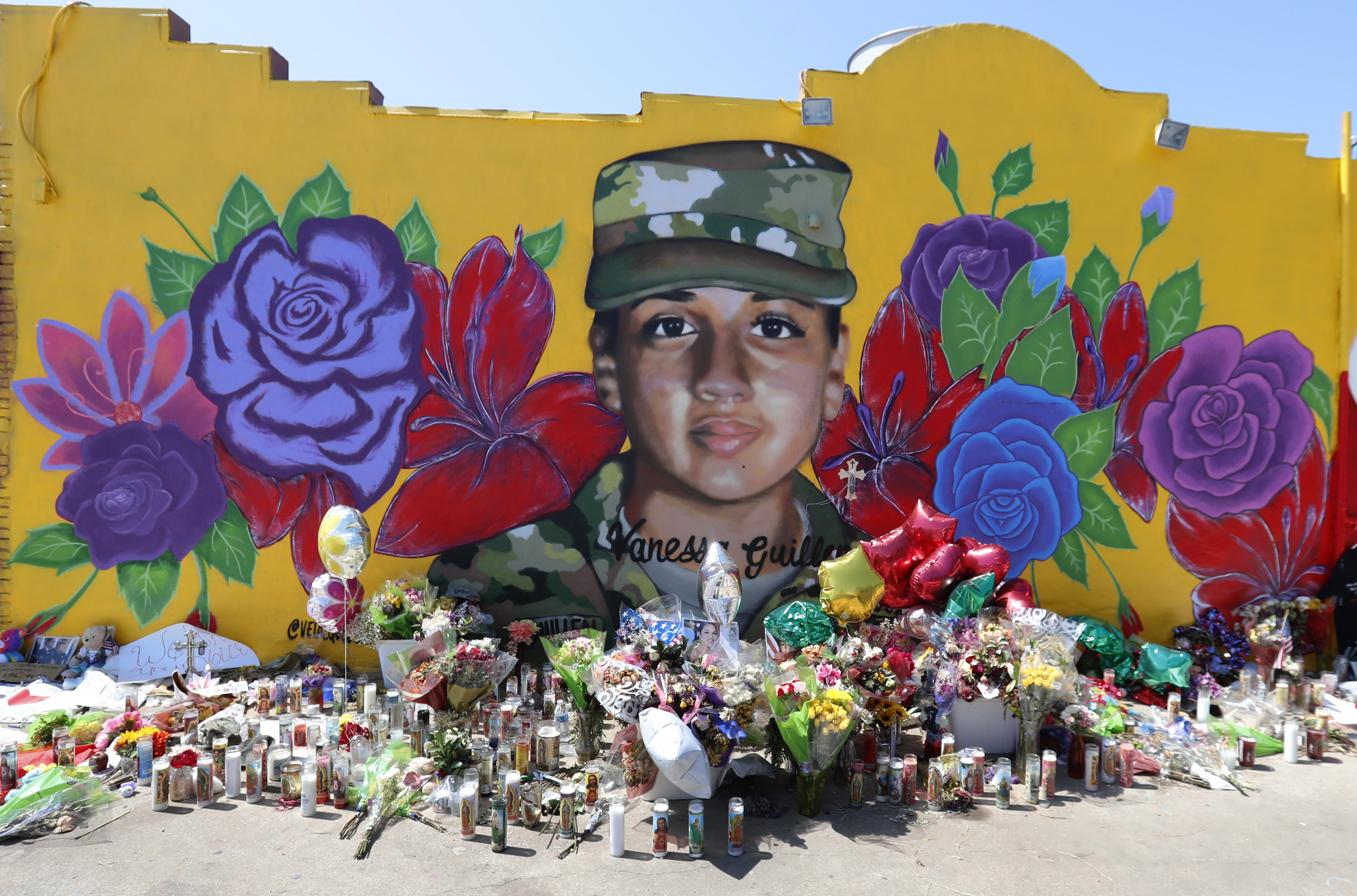 Offerings sit in front of a mural of slain Army Spc. Vanessa Guillen painted on a wall in the south side of Fort Worth, Texas on July 11, 2020. (AP Photo/LM Otero)