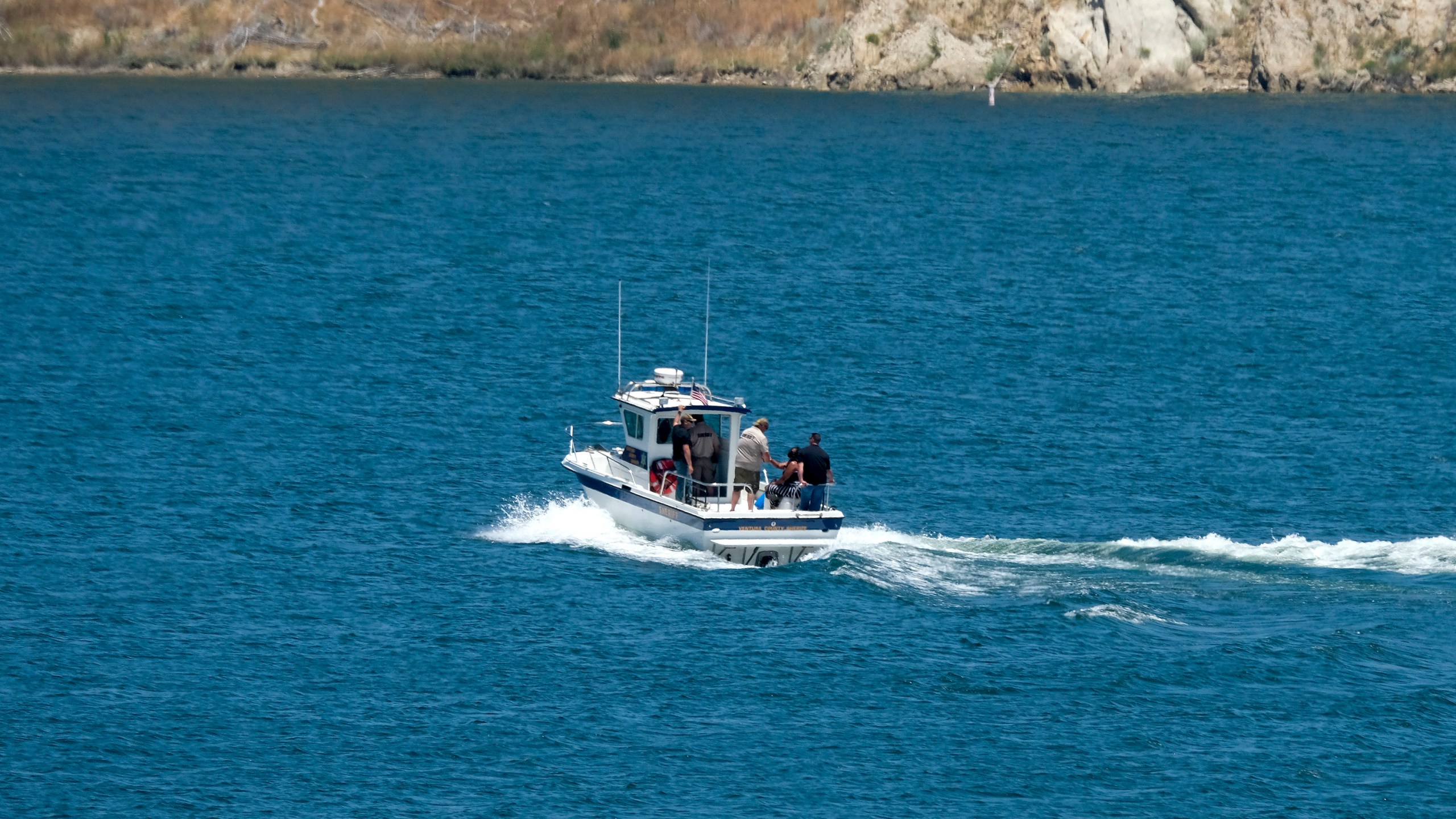 The boat of Ventura County Sheriff's Office with Naya Rivera's father, George Rivera and mother Yolanda onboard is seen after Naya Rivera's body was found in Lake Piru on July 13, 2020. (AP Photo/Ringo H.W. Chiu)