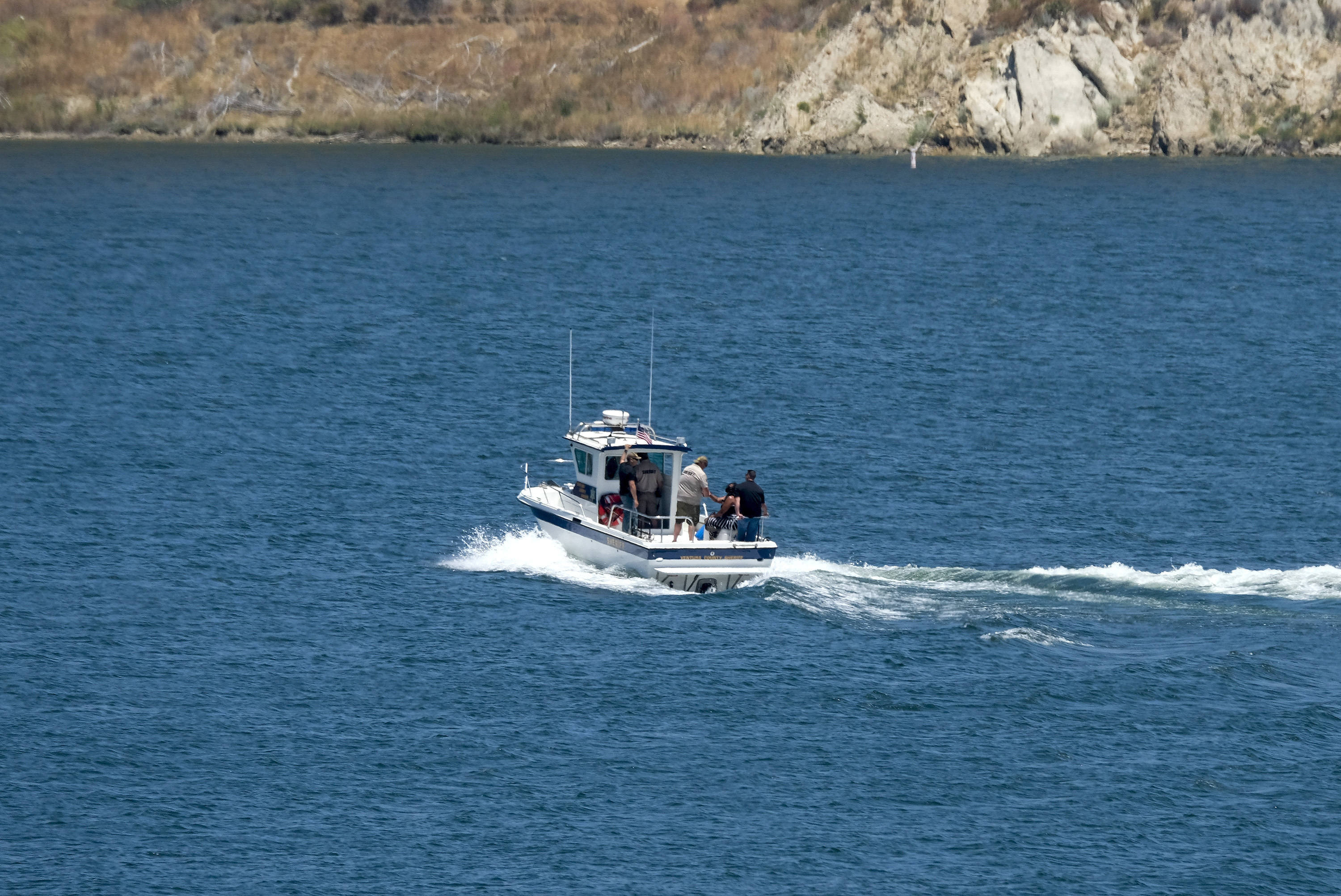 The boat of Ventura County Sheriff's Office with Naya Rivera's father, George Rivera and mother Yolanda onboard is seen after Naya Rivera's body was found in Lake Piru on July 13, 2020. (AP Photo/Ringo H.W. Chiu)