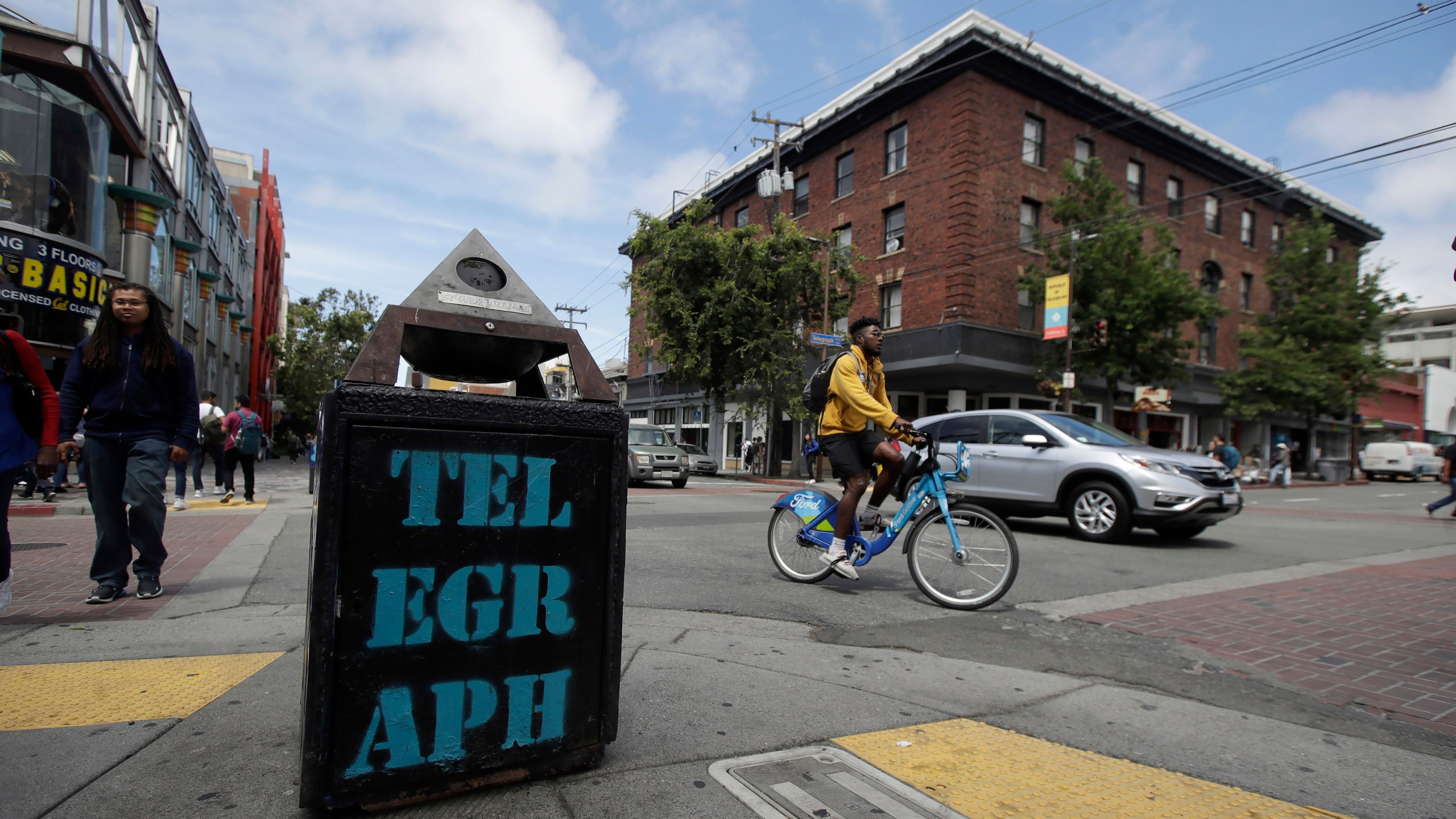 In this file photo from July 18, 2019, traffic and pedestrians cross Telegraph Avenue in Berkeley. (AP Photo/Jeff Chiu, File)