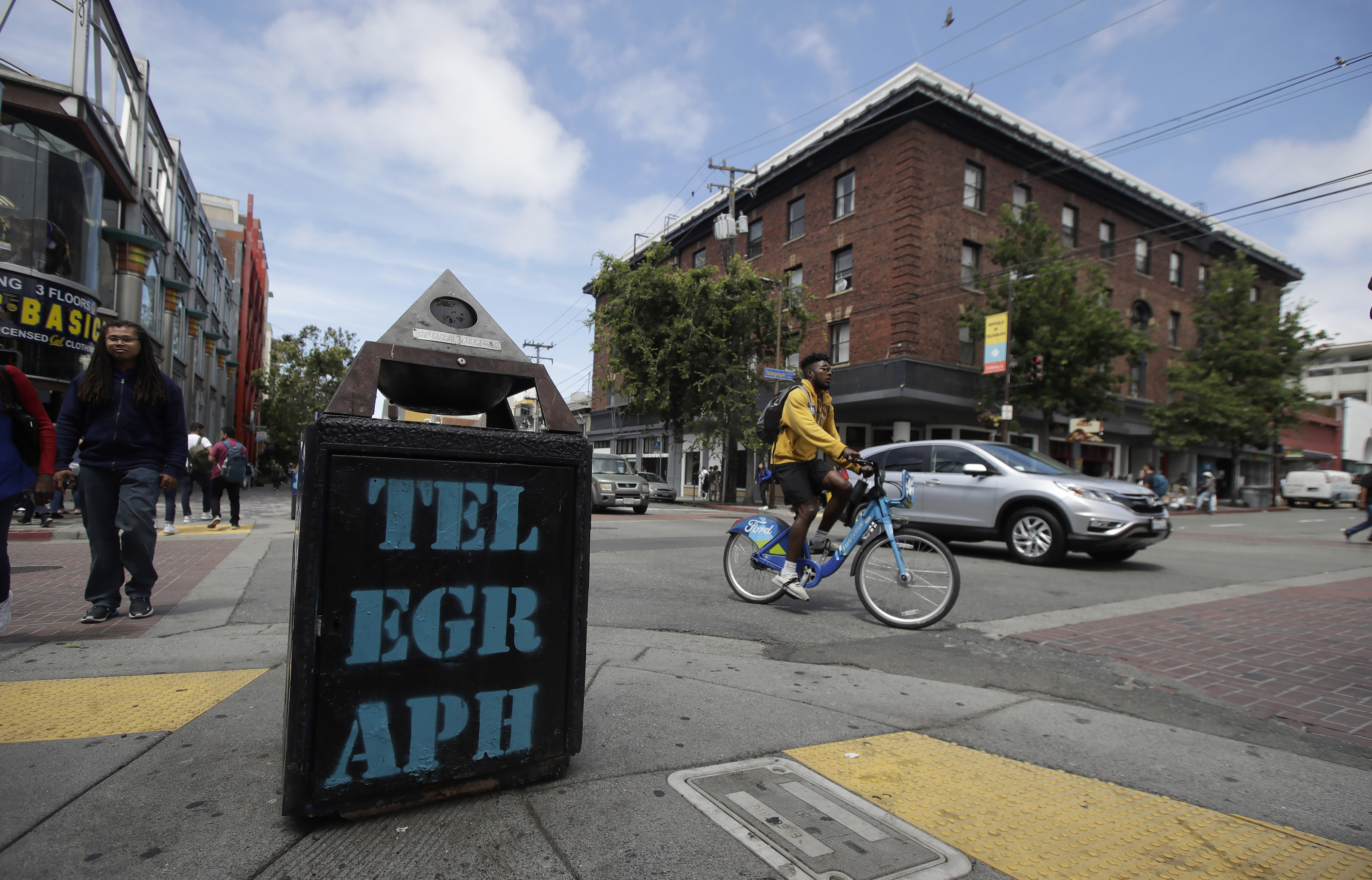 In this file photo from July 18, 2019, traffic and pedestrians cross Telegraph Avenue in Berkeley. (AP Photo/Jeff Chiu, File)