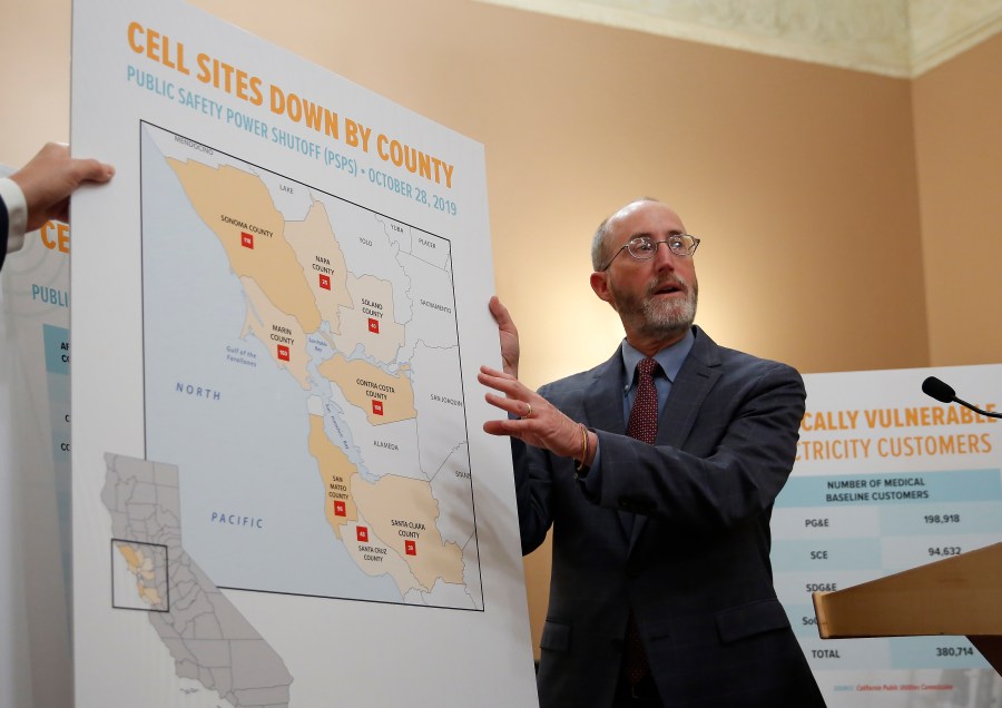 Sen. Steve Glazer, D-Orinda, displays a chart showing cell tower sites that were shut down during power outages in 2019, in Sacramento on Jan. 8, 2020. (AP Photo/Rich Pedroncelli, File)