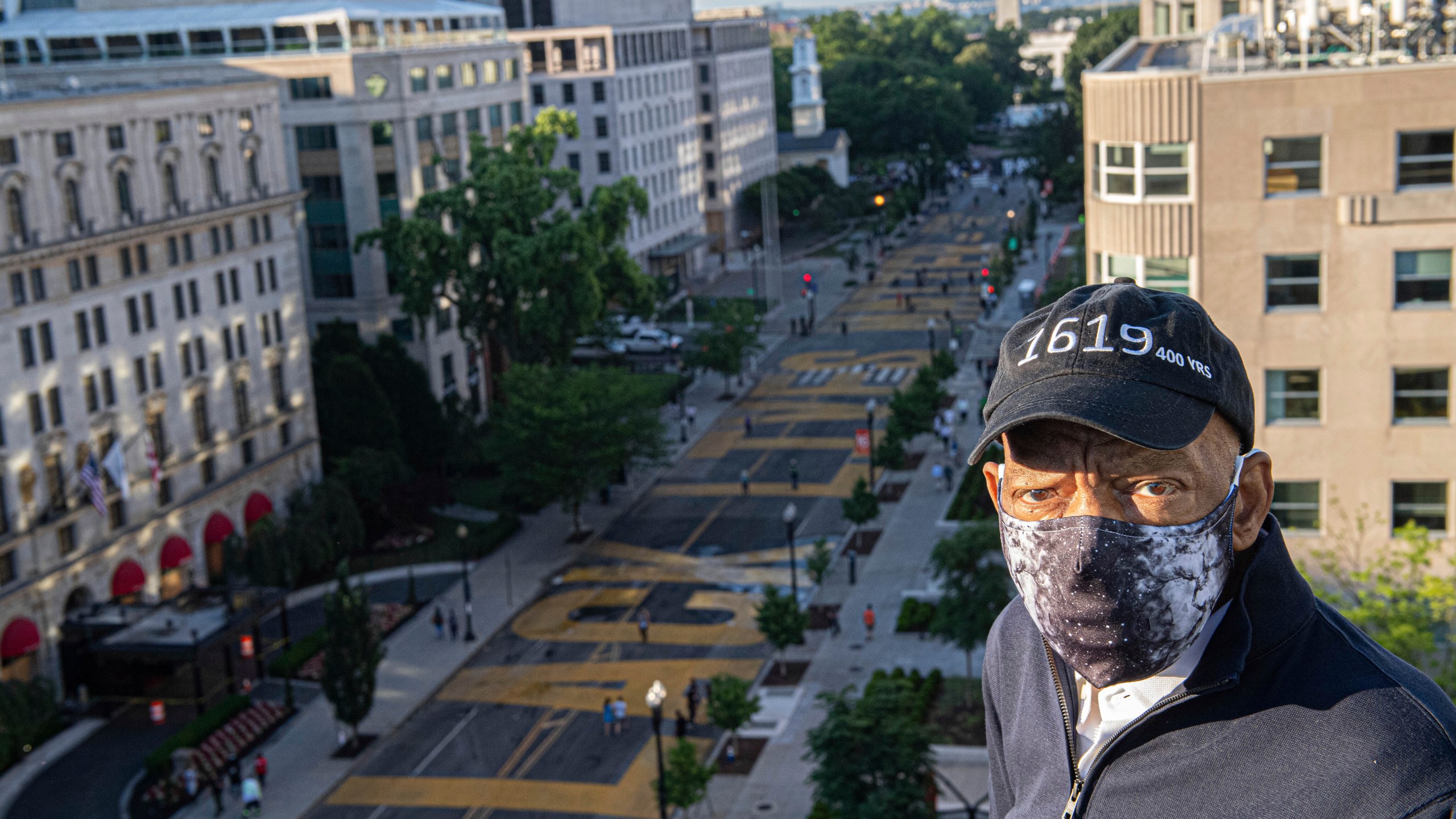 In this June 7, 2020 photo provided by the Executive Office of District of Columbia Mayor Muriel Bowser, John Lewis looks over a section of 16th Street that's been renamed Black Lives Matter Plaza in Washington. (Khalid Naji-Allah/Executive Office of the Mayor via AP)