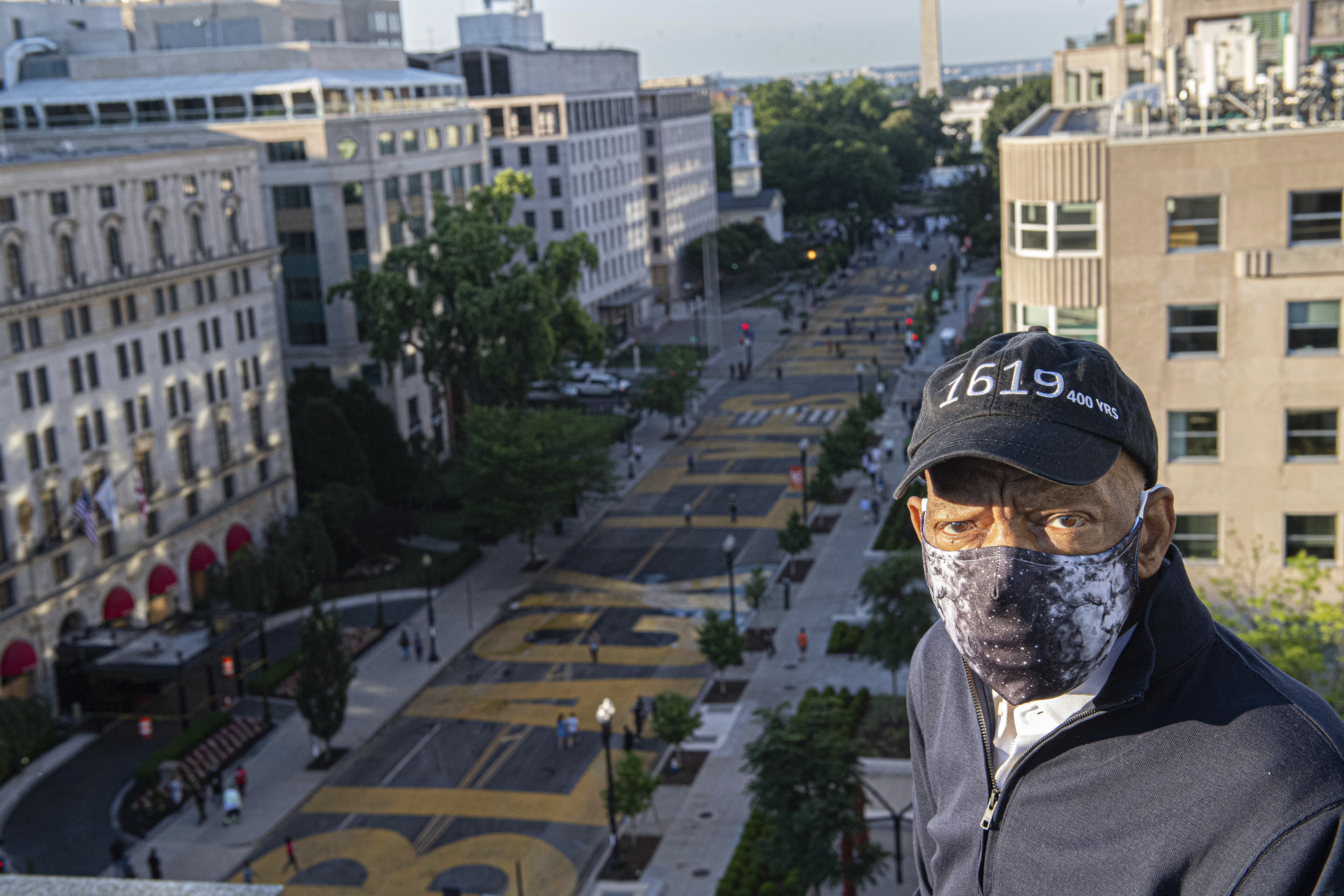 In this June 7, 2020 photo provided by the Executive Office of District of Columbia Mayor Muriel Bowser, John Lewis looks over a section of 16th Street that's been renamed Black Lives Matter Plaza in Washington. (Khalid Naji-Allah/Executive Office of the Mayor via AP)