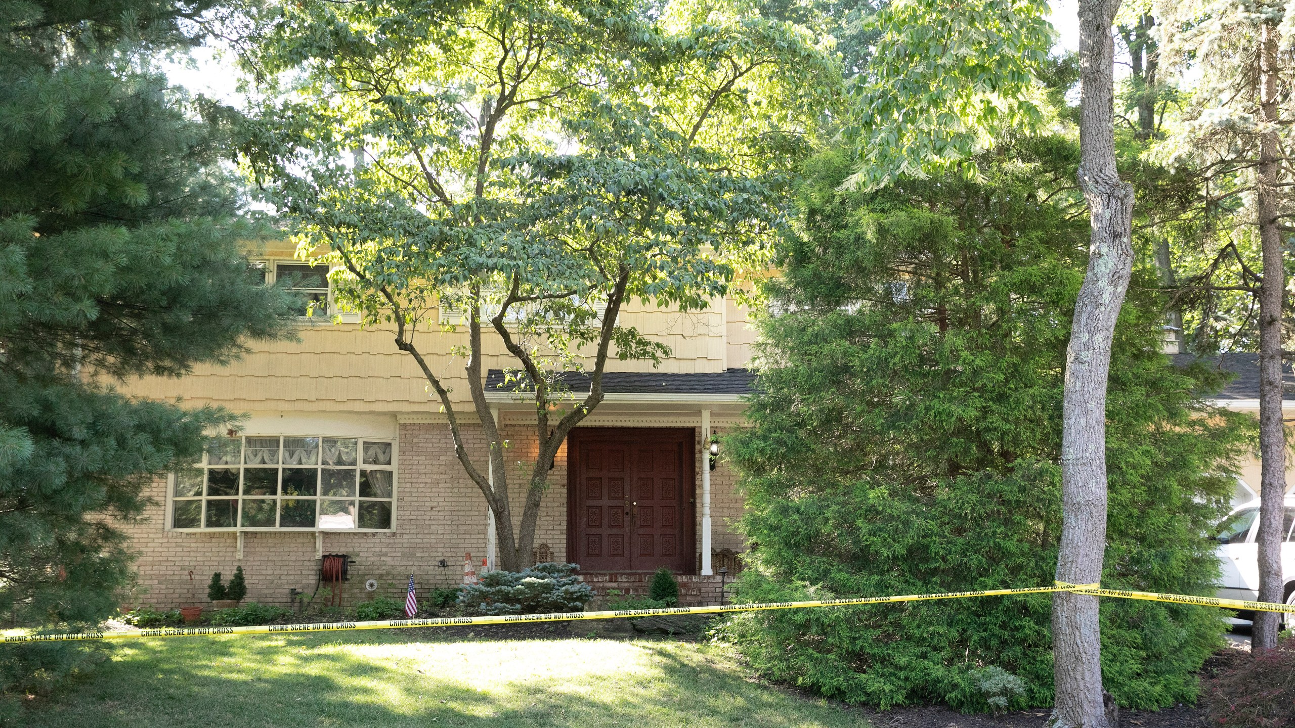 Crime scene tape surrounds the home of U.S. District Judge Esther Salas, Monday, July 20, 2020, in North Brunswick, N.J. (AP Photo/Mark Lennihan)