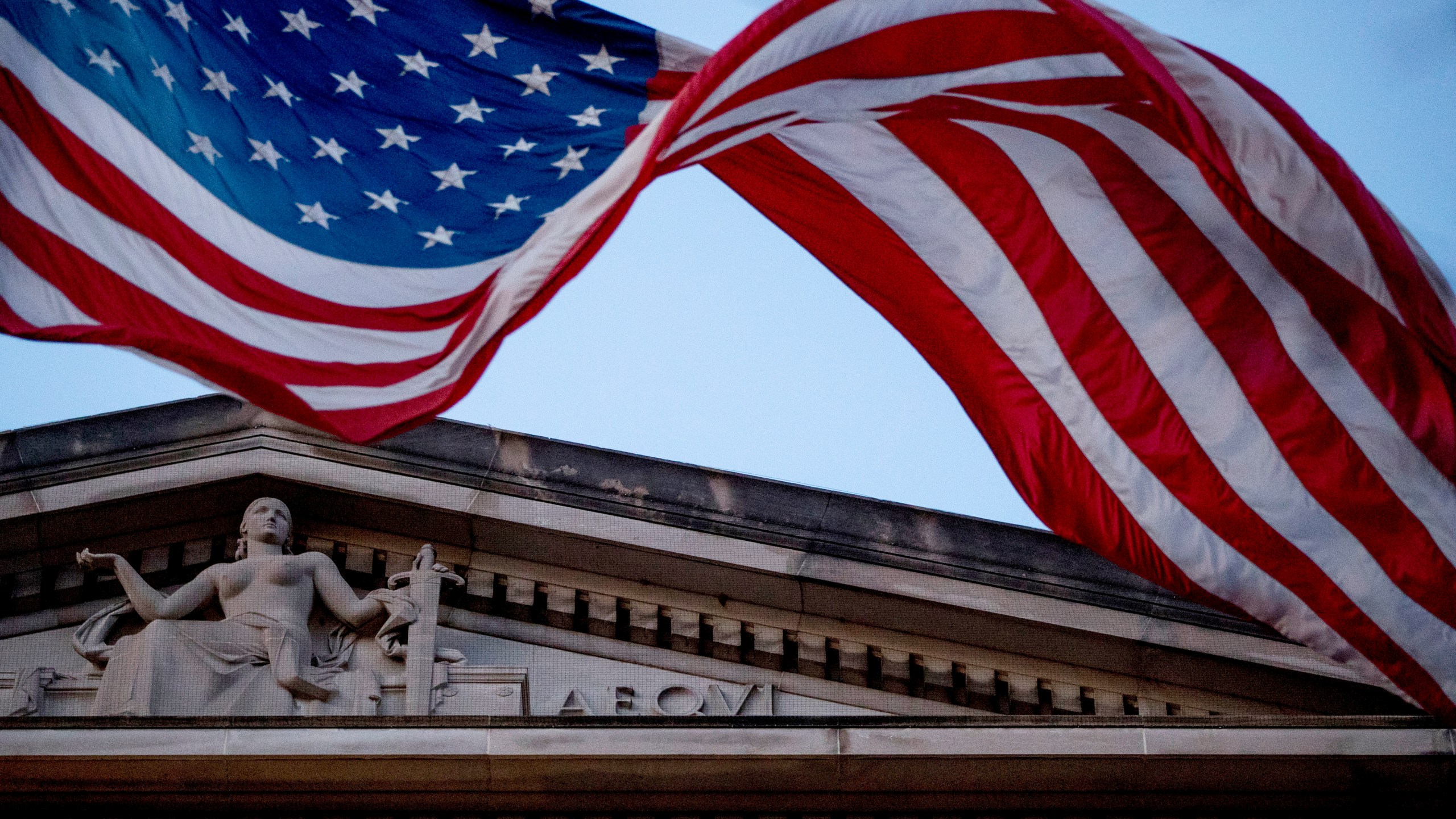 An American flag flies outside the Department of Justice in Washington in this March 22, 2019 file photo. (AP Photo/Andrew Harnik)