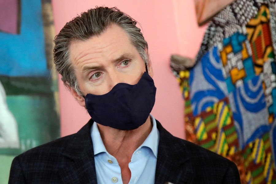 In this June 9, 2020, file photo, California Gov. Gavin Newsom wears a protective mask on his face while speaking to reporters at Miss Ollie's restaurant during the coronavirus outbreak in Oakland, Calif. (AP Photo/Jeff Chiu, Pool, File)