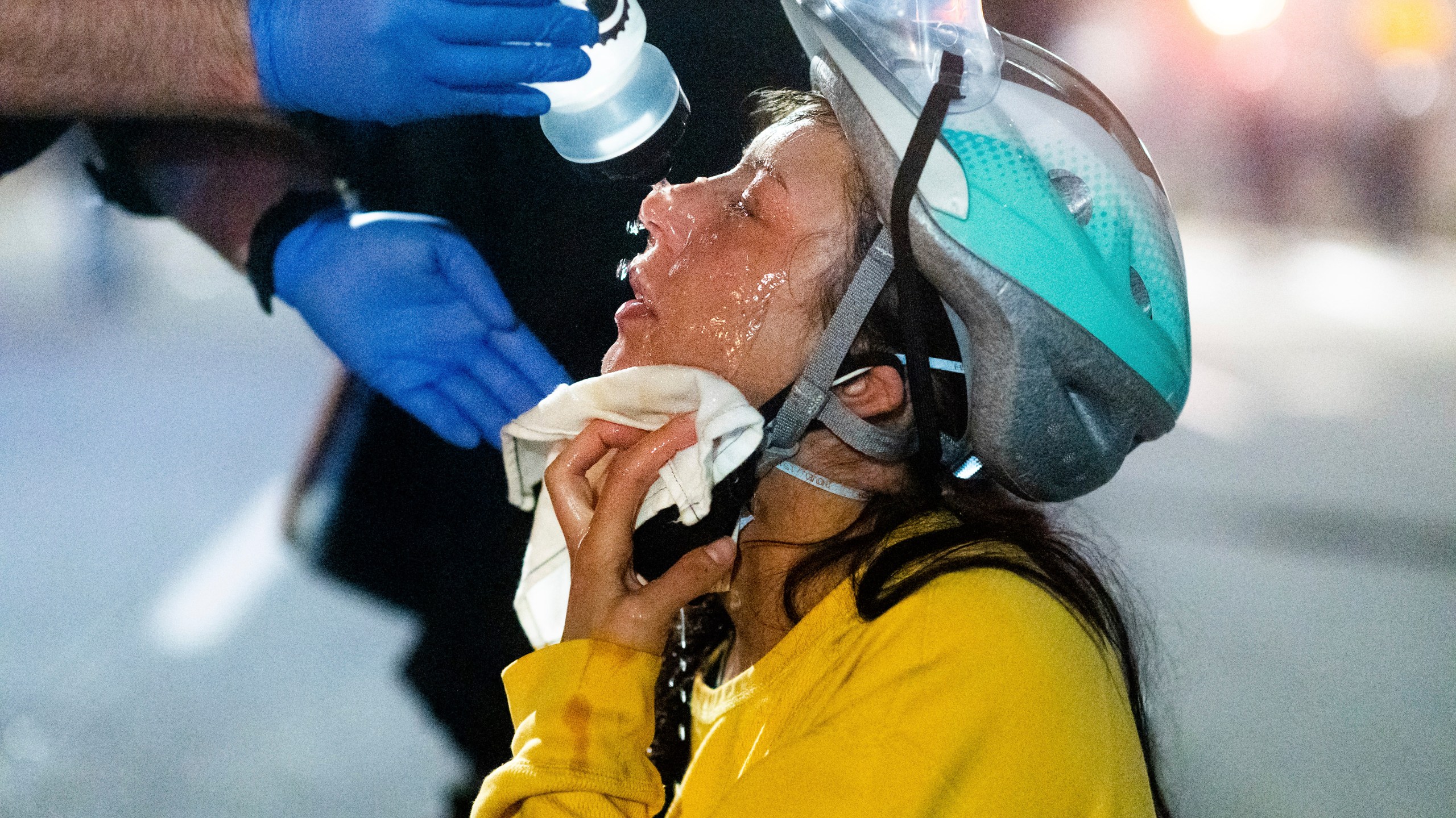 A medic treats Black Lives Matter protester Lacey Wambalaba after exposure to chemical irritants deployed by federal officers at the Mark O. Hatfield United States Courthouse on July 24, 2020, in Portland. (AP Photo/Noah Berger)