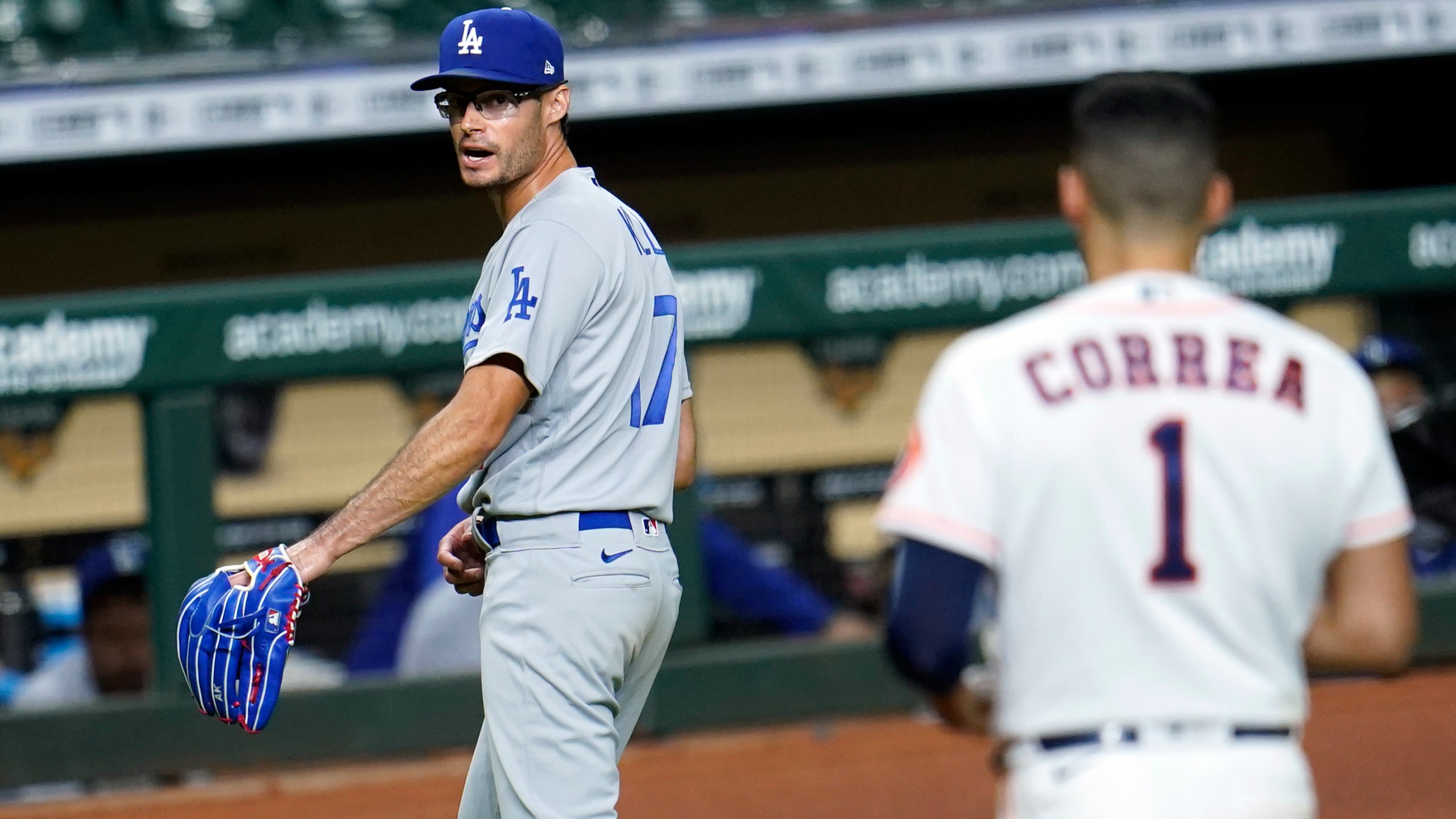 Los Angeles Dodgers relief pitcher Joe Kelly (17) looks back at Houston Astros' Carlos Correa (1) after the sixth inning of a baseball game Tuesday, July 28, 2020, in Houston. Both benches emptied during the exchange. (AP Photo/David J. Phillip)