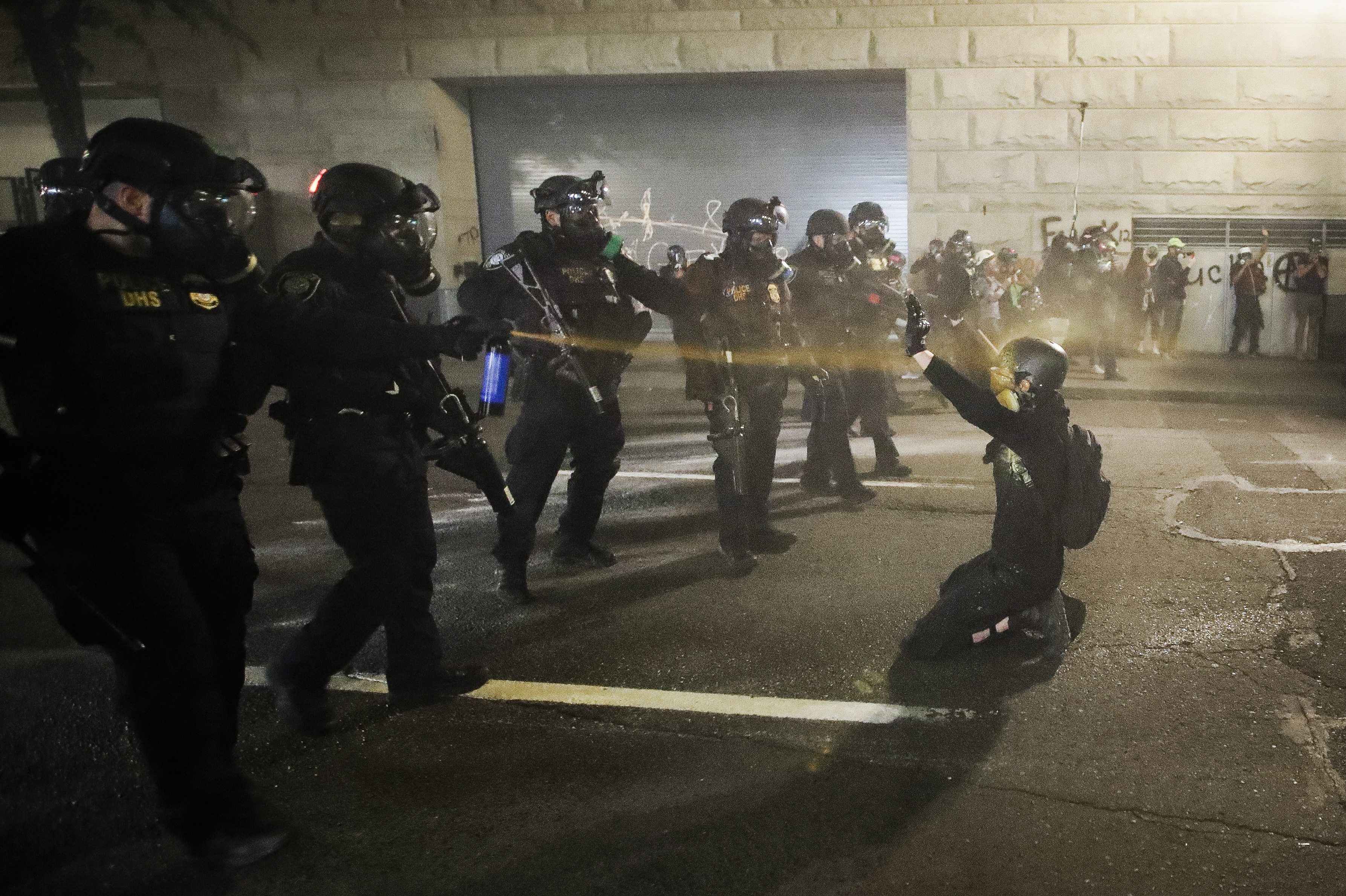 A demonstrator is pepper sprayed shortly before being arrested during a Black Lives Matter protest at the Mark O. Hatfield United States Courthouse Wednesday, July 29, 2020, in Portland, Ore. (Marcio Jose Sanchez)