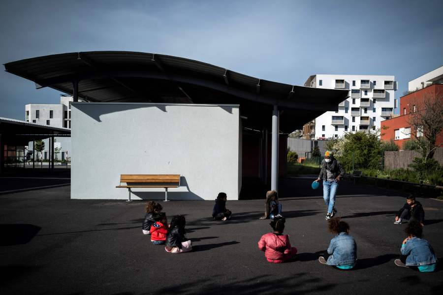 This file photo shows children sitting at a playground at the Borderouge elementary school used as a day care center during the Easter holiday, in Toulouse, southern France on April 16, 2020 (LIONEL BONAVENTURE/AFP via Getty Images)