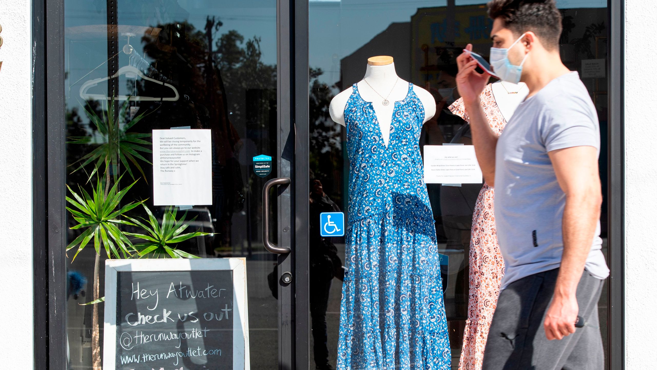 A sign displayed on the door tells the client that the shop is closed due to coronavirus amid the COVID- 19 pandemic, May 4, 2020, in Glendale, California. (VALERIE MACON/AFP via Getty Images)