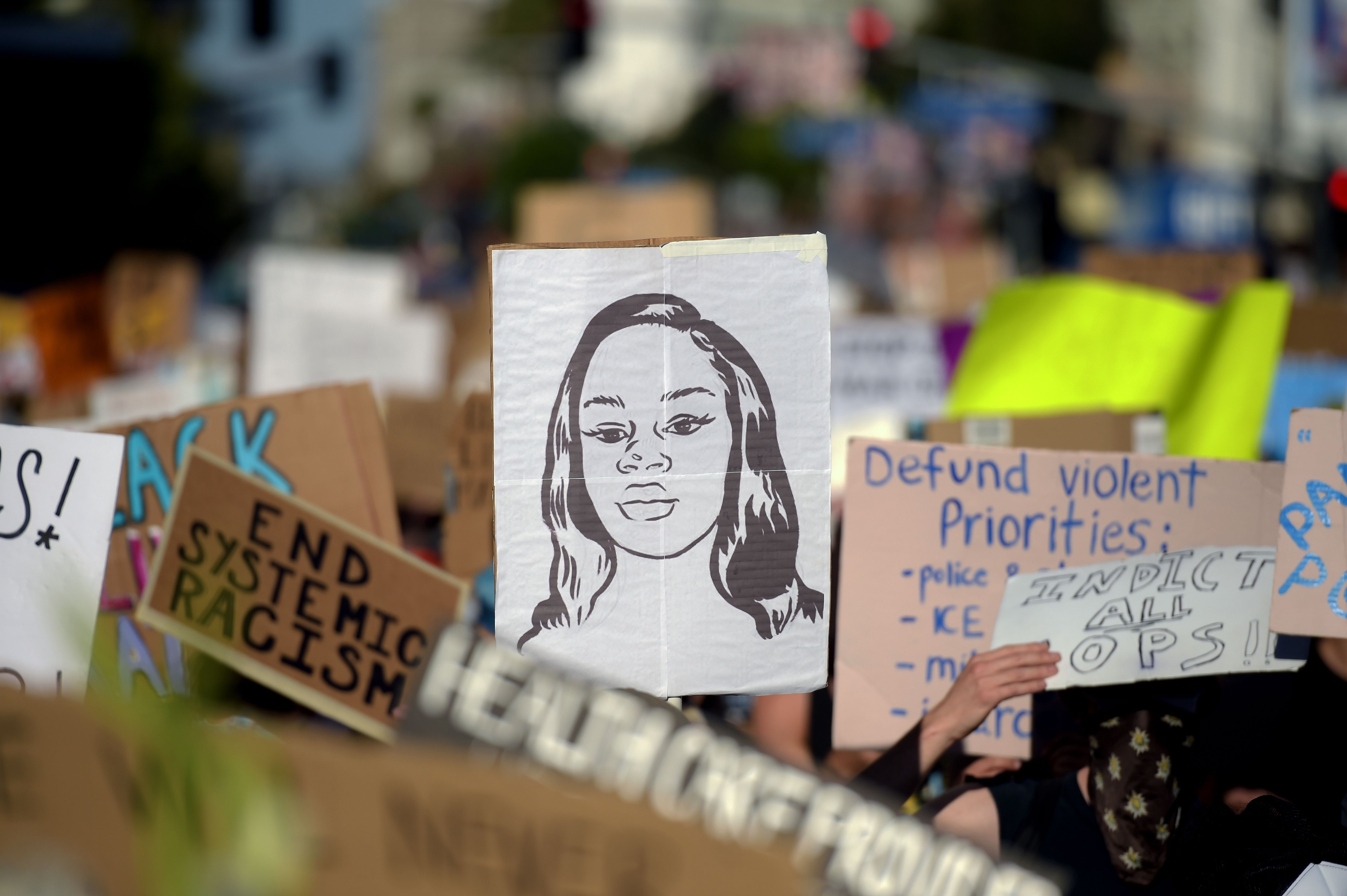 Protesters march holding placards and a portrait of Breonna Taylor during a demonstration against racism and police brutality in Hollywood on June 7, 2020. (Agustin Paullier / AFP / Getty Images)