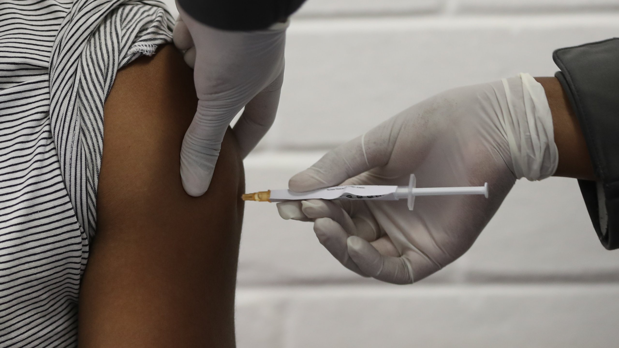 One of the first South African Oxford vaccine trialists is injected with the clinical trial for a potential coronavirus vaccine in Soweto, South Africa, on June 24 ,2020. (SIPHIWE SIBEKO/ POOL/AFP via Getty Images)