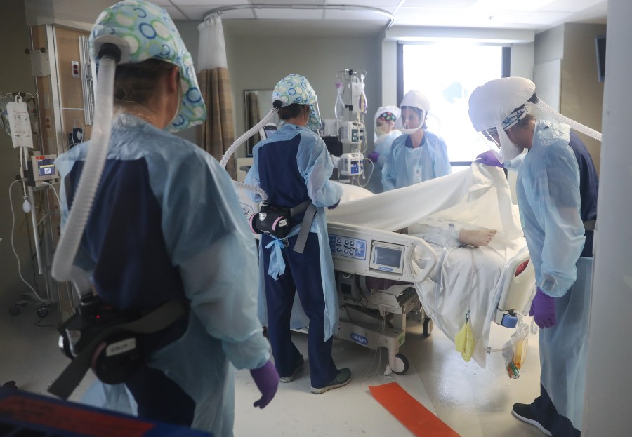 Clinicians wearing personal protective equipment care for a COVID-19 patient in the intensive care unit at Sharp Memorial Hospital amid the coronavirus pandemic on May 6, 2020 in San Diego. (Mario Tama/Getty Images)