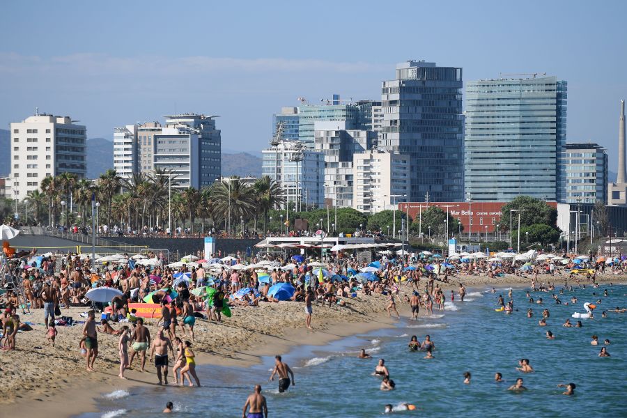 People swim and sunbathe at the Bogatell beach in Barcelona, one of the several sands of the city that have been closed on July 19, 2020, due to reaching the allowed capacity. (Josep LAGO / AFP via Getty Images)