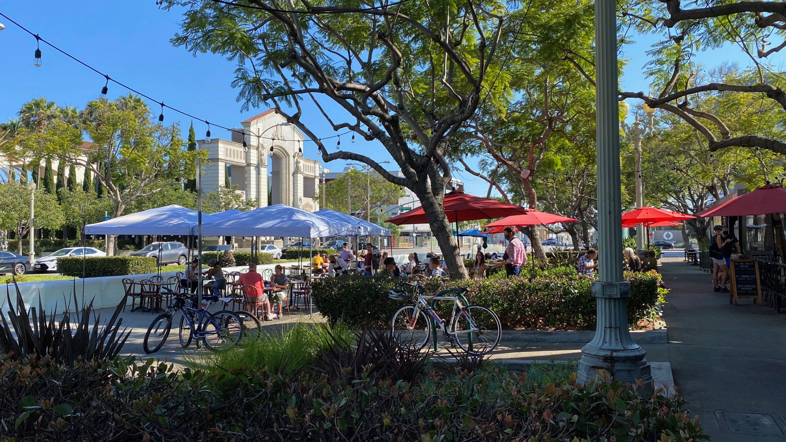 People enjoy a newly added outdoor dining area in downtown Culver City on July 25, 2020. (CHRIS DELMAS/AFP via Getty Images)