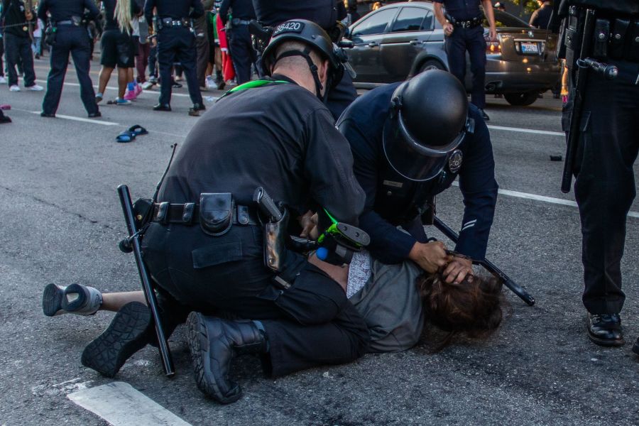 A police officer arrests Lorises Tercero in front of a federal courthouse during a protest in downtown Los Angeles on July 25, 2020. (APU GOMES/AFP via Getty Images)