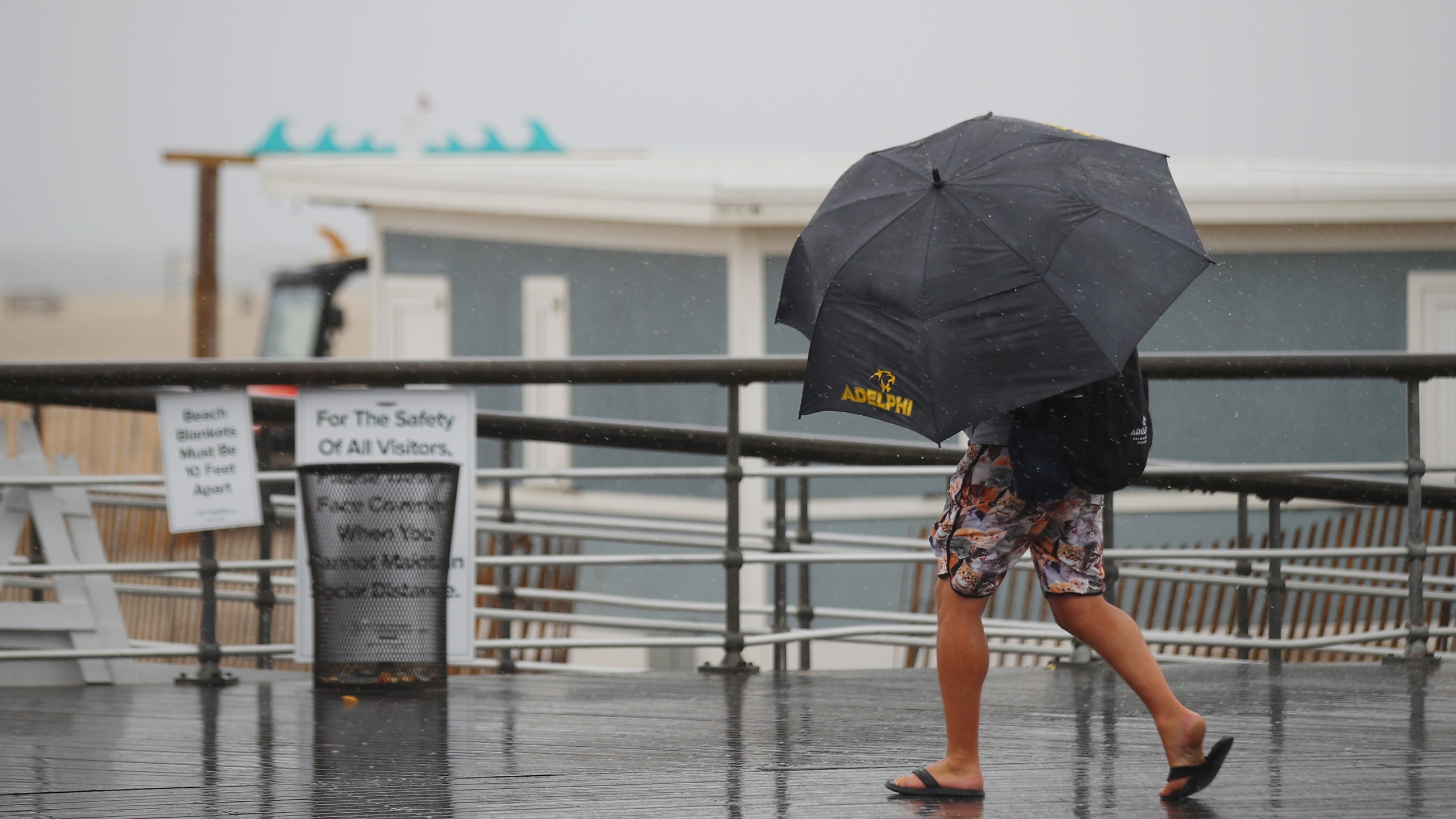 Visitors walk the boardwalk in rainy weather at Jones Beach on July 10, 2020, in Wantagh, New York. The Long Island region is bracing for Tropical Storm Fay as it moves along the eastern seaboard. (Bruce Bennett/Getty Images)