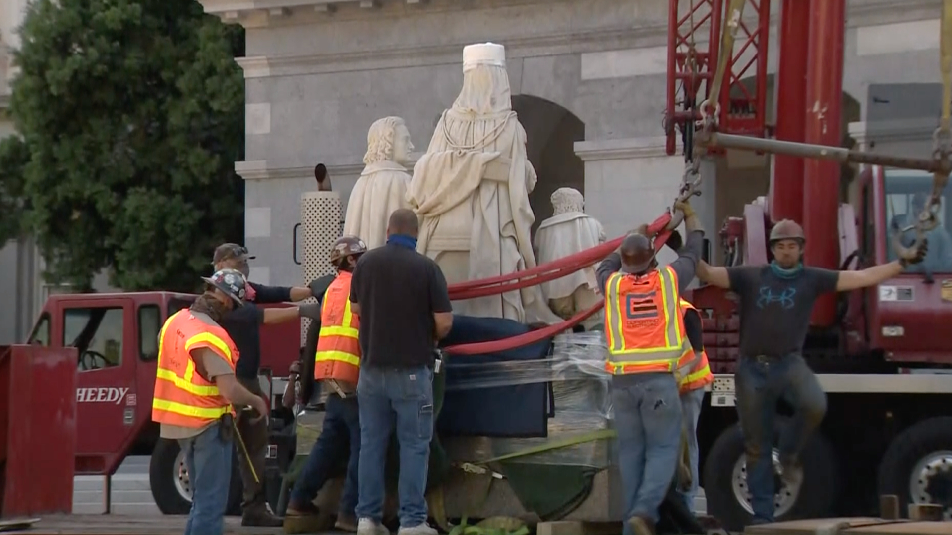 Crews remove a statue of Christopher Columbus and Queen Isabella from the California state Capitol on July 7, 2020. (KCRA via CNN)