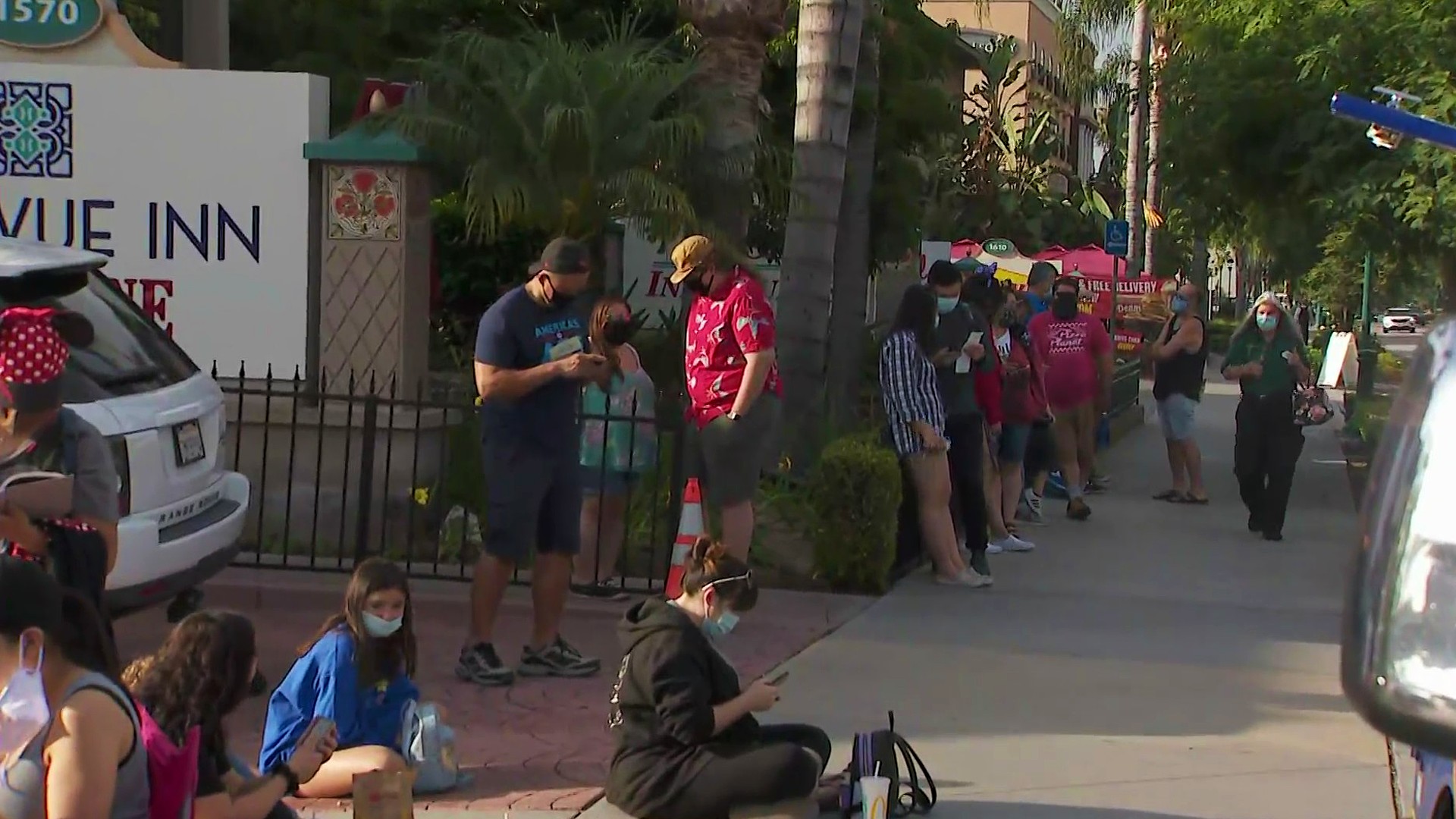 Guests lineup hours before the opening of Downtown Disney in Anaheim on July 9, 2020. (KTLA)