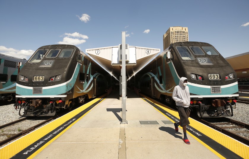 A passengers waits to board a Metrolink train to San Bernardino as other Metrolink trains stand idle at Union Station. (Al Seib/Los Angeles Times)