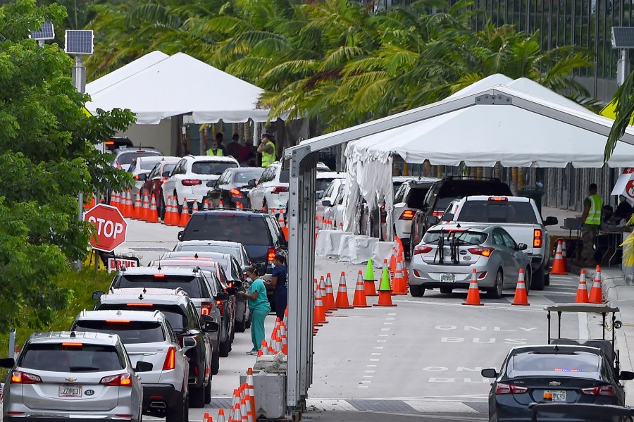 In this file photo cars line up for COVID-19 test at a "walk-in" and "drive-through" coronavirus testing site in Miami Beach, Florida on July 22, 2020. (CHANDAN KHANNA / AFP)