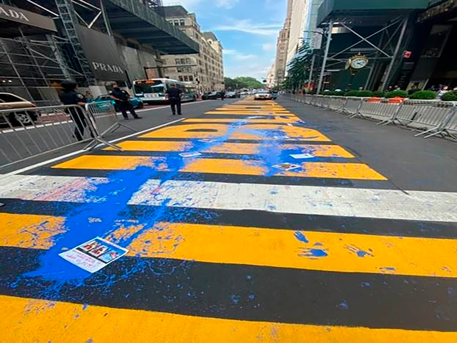 This photo provided by the New York City Police Department shows the Black Lives Matter mural in front of Trump Tower defaced with blue paint, Friday, July 17, 2020 in New York. (New York Police Department via AP)