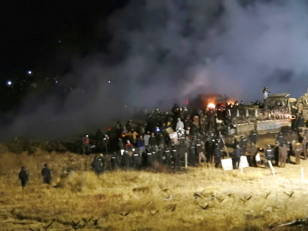 In this file photo, provided by Morton County Sheriff's Department, law enforcement and protesters clash near the site of the Dakota Access pipeline on Sunday, Nov. 20, 2016, in Cannon Ball, N.D. A federal judge on Monday, July 6, 2020 sided with the Standing Rock Sioux Tribe and ordered the Dakota Access pipeline to shut down until more environmental review is done. (Morton County Sheriff's Department via AP, File)