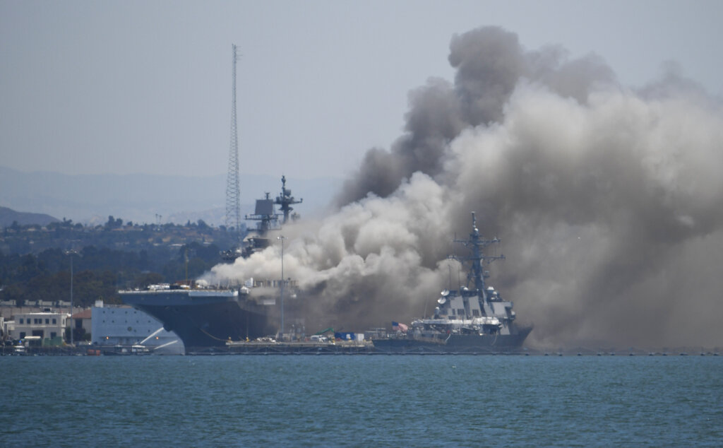 Smoke rises from the USS Bonhomme Richard at Naval Base San Diego on July 12, 2020. (AP Photo/Denis Poroy)