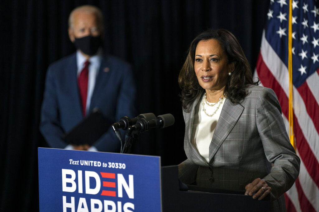 Democratic presidential candidate and former Vice President Joe Biden looks on as his running mate, Sen. Kamala Harris, speaks at the Hotel DuPont in Wilmington, Delaware on Aug. 13, 2020. (Carolyn Kaster / Associated Press)