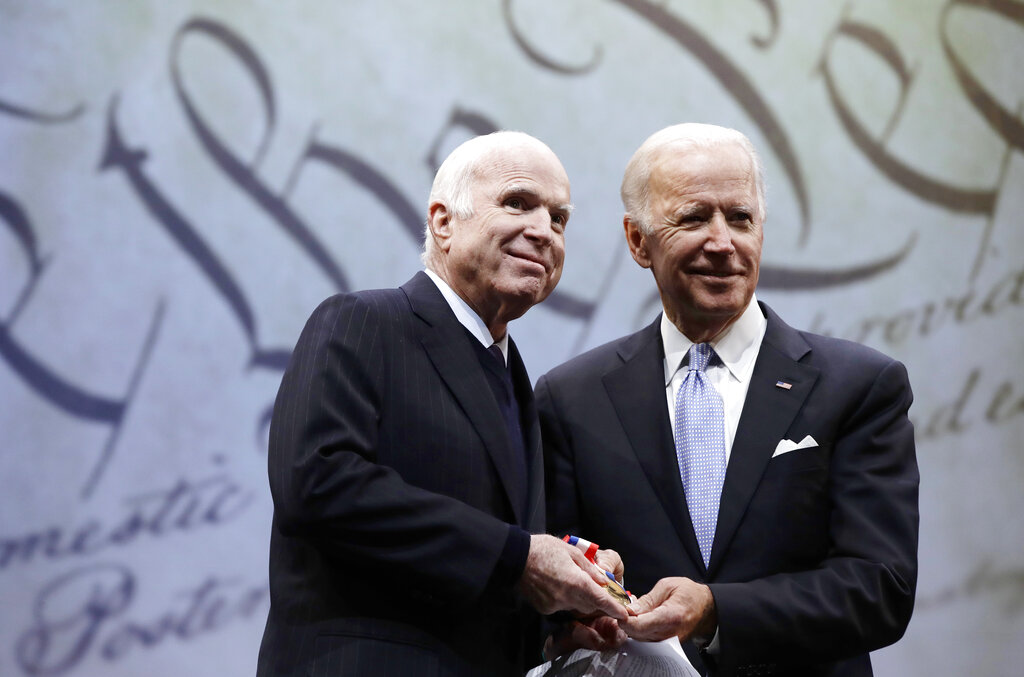 Sen. John McCain receives the Liberty Medal from former Vice President Joe Biden in Philadelphia on Oct. 16, 2017. (AP Photo/Matt Rourke)