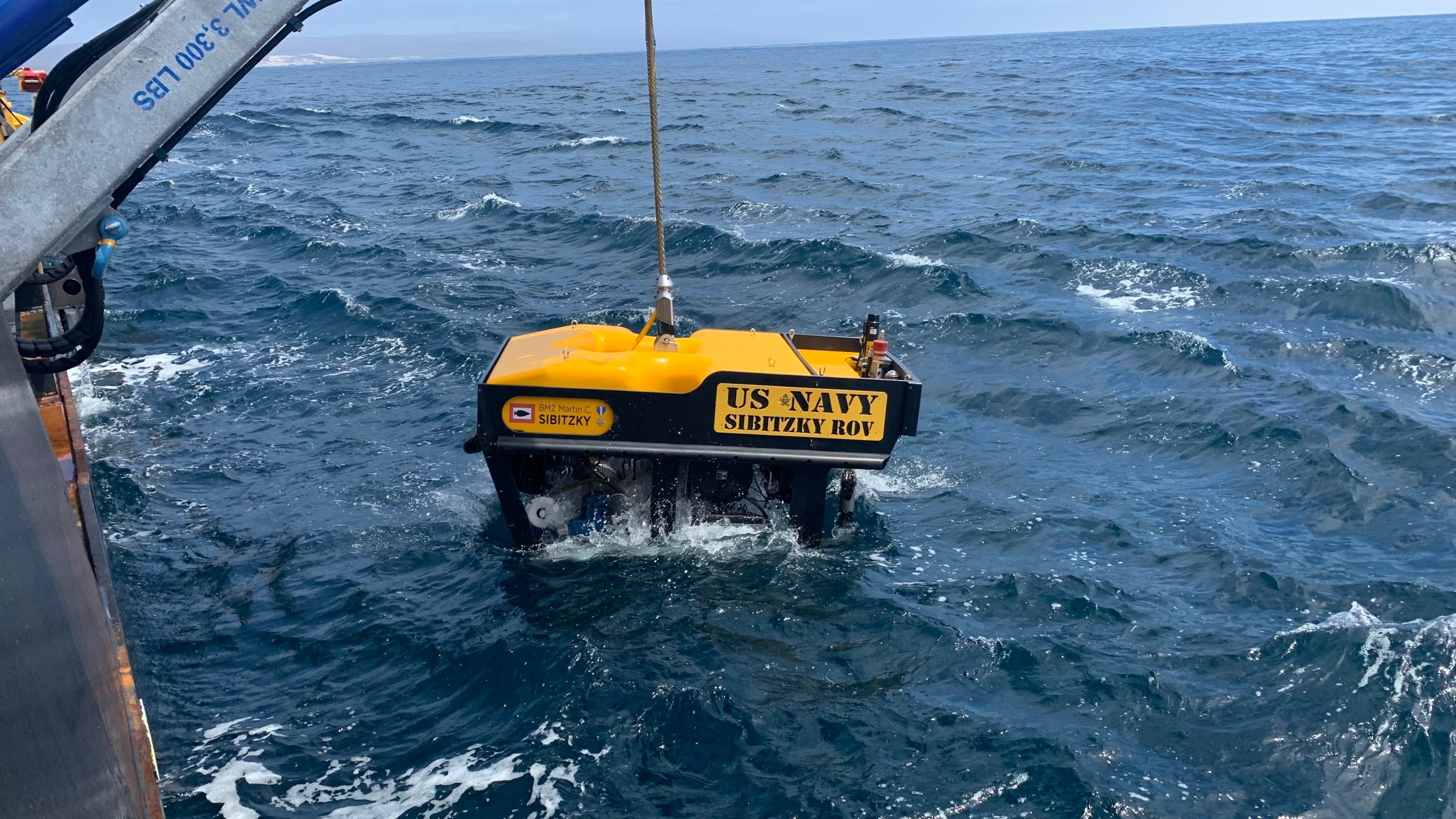 Crews deploy a remotely operated vehicle from the deck of a ship on Aug. 3, 2020, in the recovery of the seven Marines and one sailor missing off the coast San Clemente Island. (U.S. Navy / Lt. Curtis Khol)