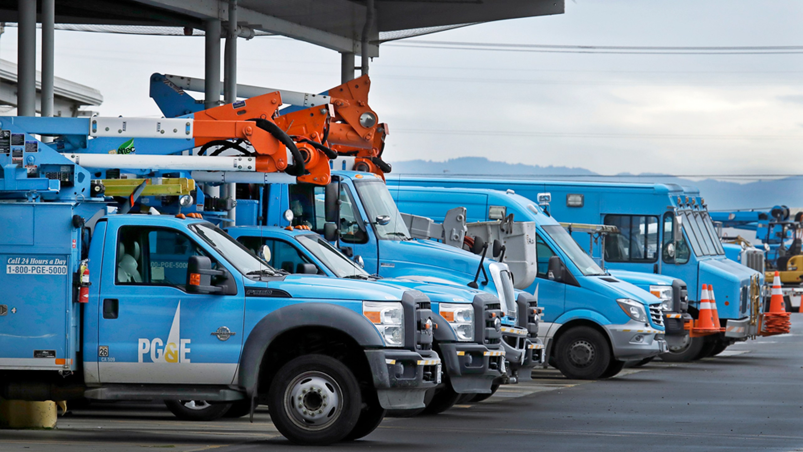 This Jan. 14, 2019, file photo shows Pacific Gas & Electric vehicles parked at the PG&E Oakland Service Center in Oakland, Calif. (AP Photo/Ben Margot, File)