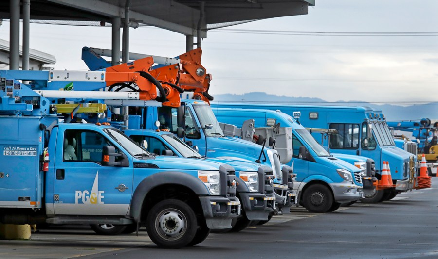 This Jan. 14, 2019, file photo shows Pacific Gas & Electric vehicles parked at the PG&E Oakland Service Center in Oakland, Calif. (AP Photo/Ben Margot, File)